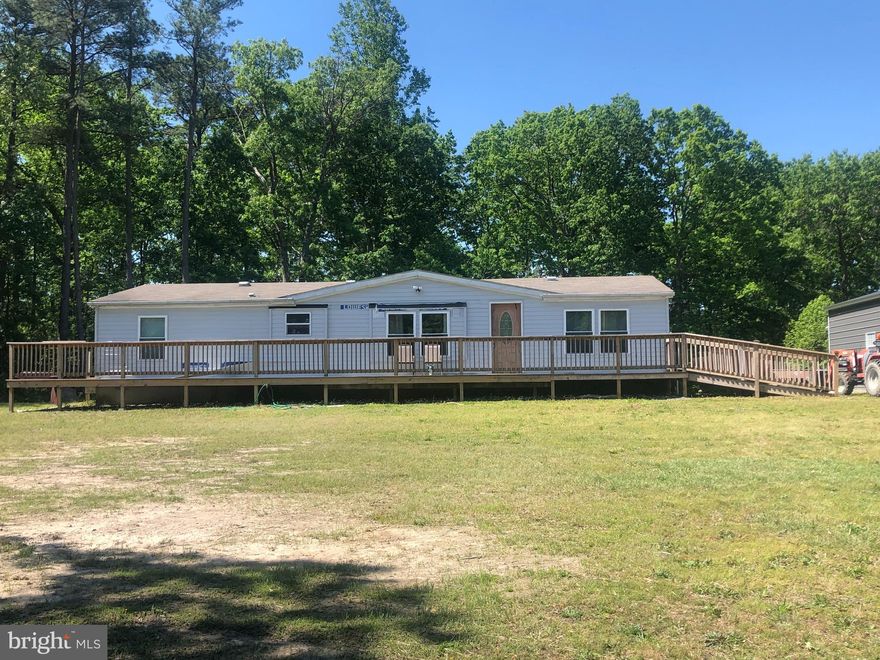 Beautiful ten acre parcel with small pond, nice manufactured home and two car garage/shed.