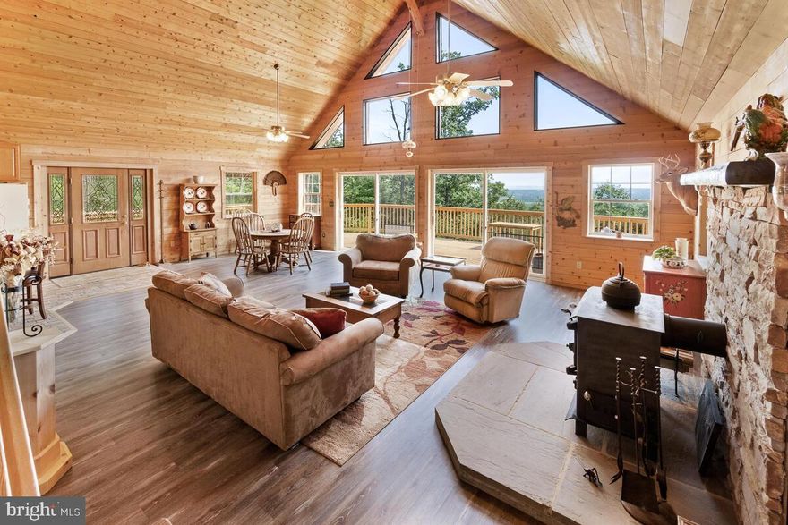 Multiple offers have been received. Sellers will review offers mid day on Sunday 2/25. Nature Lovers Paradise!  If you are seeking a private and secluded refuge from today’s stresses and want to live in peace and tranquility, this may be your new home!  Perched high atop the mountain behind Mt. Saint Mary’s College with AMAZING VIEWS looking all the way down to Sugarloaf Mountain, you can sit on your expansive deck and watch fireworks in the distance and nature up close.  Check out the virtual tour to see what this property is all about.  The bonus to this amazing property is the awesome home that goes with it!  This A-Frame is beautiful!! The owners did a fantastic job updating it with brand new gutters and fascia, new deck boards, new paint,  new flooring, newer roof, and newer HVAC!  Look at the pictures, this place is beautiful!  Primary bedroom and bath located in the loft with two additional bedrooms and full bath on the main level.  From almost anywhere you stand within this home, you can see the magnificent mountainous views through the floor-to-ceiling, two-story windows.  The windows act as solar heat in the winter, cutting your fuel bill significantly!  There is storage under the home and sheds on the property.  The property is steep and wooded, probably not suitable for large-scale gardening/farming or bringing big equipment, trailers and boats up and down.  It is perfect for relaxing, hunting, hiking, mushroom farming, chickens, goats and more!  4-WD or AWD vehicles are ideal for the unpaved, steep, and rutted driveway/private road.