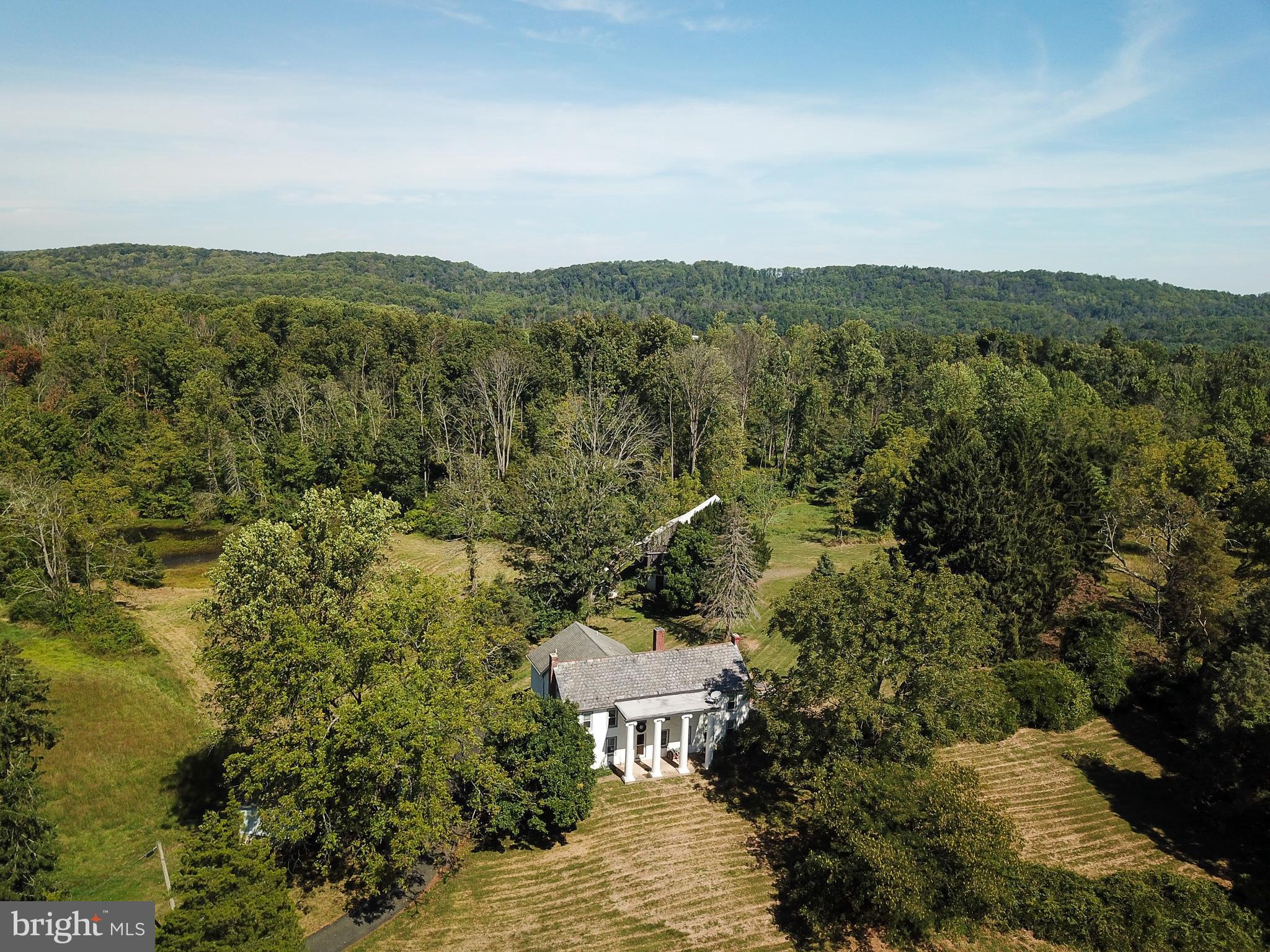 Deep Creek Farm is available for the first time in several generations. This exceptional property on an impressive 78.11 Acres is a rare find indeed. Situated in a quiet pocket in New Hanover Township surrounded by other large tracts and low-density zoning, this idyllic gem offers a vast list of possibilities. Just over 2 hours from Midtown Manhattan and 1 from Philadelphia, it could be the retreat from the madness your inner self has been aching for. Dream of a life where your hands and hard labor bring you deep satisfaction from the land? It's here. Do you have an agricultural opportunity? The topsoil is deep and fertile and the pastures are well-drained and sunny. Timber? Check. Pond? A beauty. Are you a hunter seeking a natural preserve? Indeed, generations to come can live off this prime land. Have you been seeking the perfect spot that's isolated from all neighbors and prying eyes for your side gig? At last, you've discovered it. A true family compound that sustains and shelters all of your loved ones and their families? Yes. Perhaps a development opportunity that preserves the impressive residence on 60-plus acres and offers a way to spin off a great deal of cash for your future. Yes, Deep Creek Farm presents an excellent option for that. The residence is a perfect blend of a practical colonial and a grand estate with features like a four towering Antebellum Column facade with a surprising historical tale. How about a lavish 500 square foot master bedroom with a soaring ceiling? There is a modern and stylish kitchen in the heart of the living space, and a huge living room with beamed ceilings and an immense stone fireplace. Recent additions with den and solarium space, a walkout basement and of course a 40X20 Anttique timber framed barn for all the treasures in your life. If this sounds like something that is worthy of your time to investigate, your hunch is correct. This opportunity to live very differently is increasingly rare. In the literally 3.4 million square feet of paradise that is Deep Creek Farm, you will find your peace and revel in your great find.