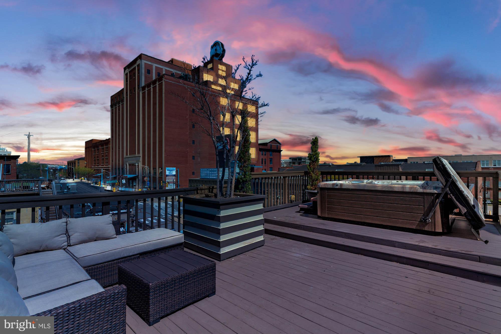 GEORGOUS 4 LEVEL CANTON HOME WITH 2+ OFF STREET PARKING AND A 2 TIER ROOFTOP W/HOT TUB(HOT SPRINGS) LOOKING AT THE BALTIMORE SKYLINE. THIS 3 BEDROOM, 2.5 BATH TOWNHOUSE HAS BEAUTIFUL HARDWOODS, CUSTOM MOLDINGS, EXPOSED BRICK & CUSTOM LIGHTING THROUGHOUT. GOURMET KITCHEN WITH GRANITE & STAINLESS STEEL APPLIANCES. SUN DRENCHED ROOMS IN THE LIGHT AND BRIGHT HOME WELCOME YOU TO THIS 3,000+ SQ FT HOME. THERE IS A FULL UNFINISHED LOWER LEVEL WHICH WOULD BE AN AMAZING HOME GYM OR GREAT FOR STORAGE. THE 2 TIER DECK IS AMAZING & OFFERS LOW VOLTAGE LIGHTING AND IRRIGATION. THIS IS A SMART HOME AND MOST EVERYTHING CAN BE DONE REMOTELY FROM YOUR PHONE! THIS ON HAS IT ALL!
