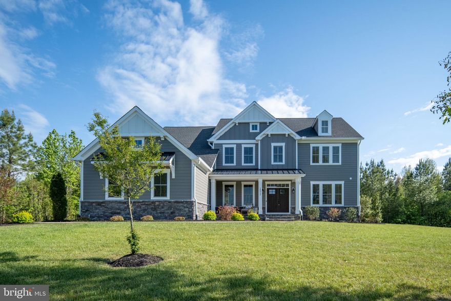Welcome to 10912 Downton Avenue—an exceptional custom estate nestled on 5 private, wooded acres in the sought-after Fortunes Landing community of Spotsylvania. Built in 2022 by the renowned and award-winning Simply Home, this stunning residence offers over-the-top craftsmanship, thoughtful design, and the perfect blend of luxury and everyday comfort.

From the moment you arrive, the home’s commanding presence and peaceful natural setting make a lasting impression. Step inside to discover white oak hardwood floors flowing throughout the main living areas and a breathtaking two-story living room, where soaring ceilings and exposed wood beams create a dramatic yet inviting focal point filled with natural light.

At the heart of the home, the gourmet chef’s kitchen is designed to impress and perform—featuring an oversized island, gleaming quartz countertops, custom soft-close cabinetry, and a spacious walk-in pantry. Whether hosting gatherings or enjoying a quiet evening at home, this space seamlessly connects function and style.

The main level also offers incredible flexibility with a private bedroom suite—perfect for guests or multi-generational living—as well as a large, dedicated home office ideal for remote work or creative pursuits.

Upstairs, the luxurious primary suite serves as a true retreat, complete with a spa-like bath and a thoughtfully designed walk-in closet. Three additional spacious bedrooms complete the upper level, including one with its own private bath and two connected by a convenient Jack-and-Jill bathroom. A generously sized laundry room adds ease and efficiency to daily living.

The finished basement expands your living space even further, offering an expansive recreation room perfect for movie nights, game days, or entertaining. A private guest suite with a large bedroom and full bath provides comfort for visitors, while a substantial unfinished area offers endless possibilities for storage or future customization.

Outdoor living is just as impressive, with a composite deck overlooking the tranquil, wooded surroundings—an ideal space for relaxing, entertaining, or simply enjoying the beauty of nature.

Located in the serene community of Fortunes Landing with access to the Ni River Reservoir, this property offers the rare combination of privacy and convenience—just a short drive to the shops, dining, and historic charm of Fredericksburg.

10912 Downton Avenue is more than a home—it’s a lifestyle defined by space, craftsmanship, and connection to nature.