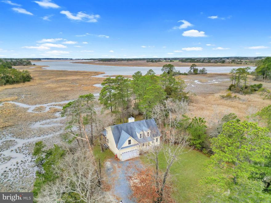 Experience waterfront living on the Wicomico River in Princess Anne, MD! Situated on 10.8 acres with approximately 3.5 acres of uplands, this 4-bedroom, 2.5-bath home offers privacy, space, and beautiful natural surroundings. A covered front porch welcomes you inside, where you’ll find a versatile flex room just off the entry—perfect for a formal dining room, home office, or playroom. Continuing through the home, the spacious living room features vaulted ceilings and a cozy fireplace, creating an open and inviting feel. The kitchen is equipped with stainless steel appliances, granite countertops, and ample cabinetry. A convenient first-floor laundry area with cabinets above and a half bath add to the home’s functionality. The primary suite is located on the first floor and offers tray ceilings, private access to the back deck, and a well-appointed en-suite bathroom complete with a dual sink vanity, soaking tub, and walk-in shower. Upstairs, you’ll find three additional bedrooms that share a full bathroom, providing plenty of room for family or guests. Enjoy outdoor living with both a deck and screened porch, perfect for relaxing while taking in the peaceful waterfront setting. With a 2-car attached garage and expansive acreage along the Wicomico River, this property offers a rare opportunity to own a private retreat on Maryland’s Eastern Shore.