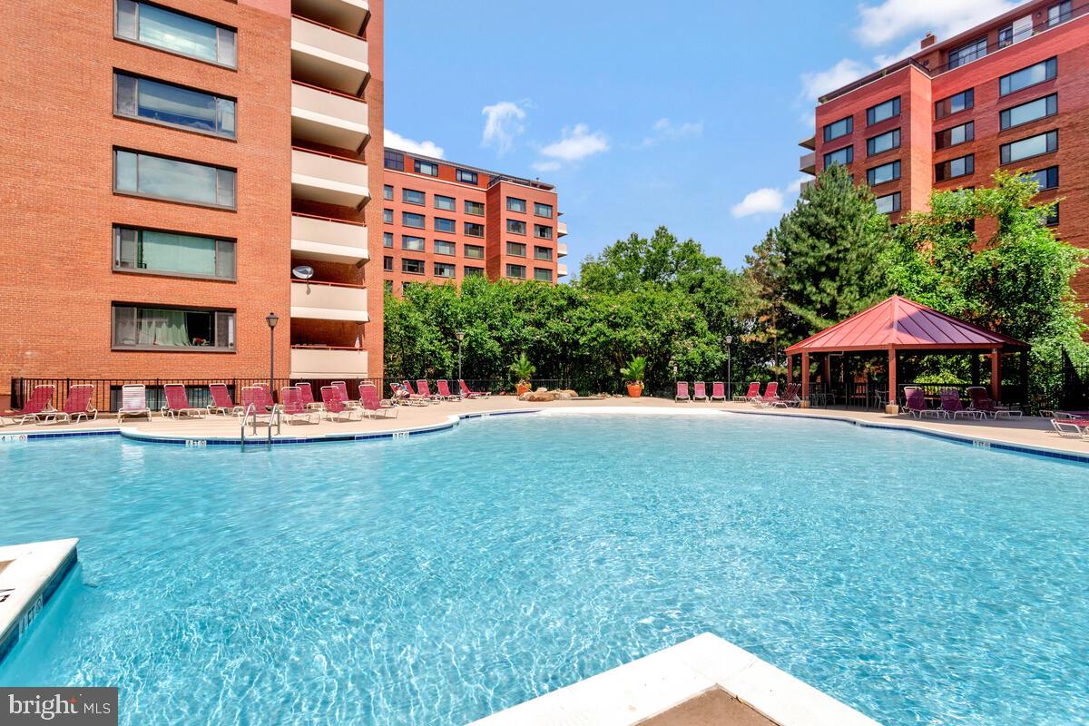 Sun-kissed, corner unit apartment with huge windows, picturesque balcony, and resort-style pool! Kickback and relax in your spacious living room/combined dining area after chefing a meal in your updated kitchen with granite countertops, cherrywood cabinets, and natural gas stove/range. Calming bathtub awaits in your updated bathroom. Newer, bleached-gray vinyl plank flooring throughout. Live in luxury at gated, amenity-rich River Place enjoying the resort-like pool with cabanas, chaise lounge chairs, and lap lanes plus well-equipped fitness center and recreational area (billiards, etc.). There's even a tree-covered, on-site market, barber, and ice cream shop! Welcoming front desk concierge. Utilities included. Garage parking included. Within 1.5 blocks of Rosslyn Metro (Blue, Orange, and Silver Lines) and 1.5 miles of Arlington Courthouse Plaza, AMC Theater, Quarterdeck, Tupelo Honey Southern Kitchen & Bar, and Whole Foods Market. Visit before it's gone!