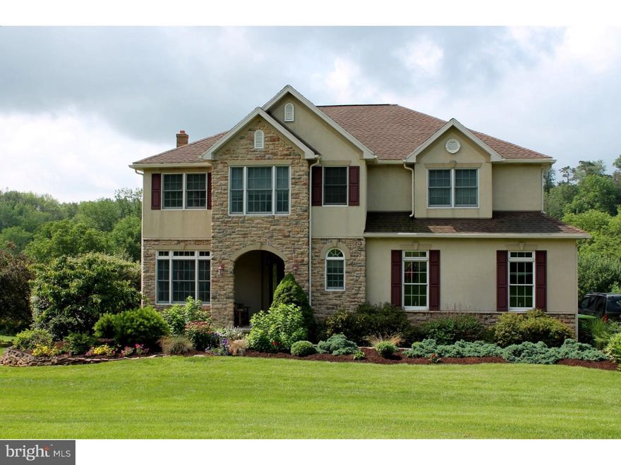 As you approach the property you will immediately notice the attention to detail in the landscaping surrounding the front walkway.  Enter the charming portico porch accented by a stone archway. Entering the home you find a functional floor plan. The tile entry leads to the dining room with hardwood.  The breakfast area and living room lead to the oversized deck to relax and enjoy those beautiful days.  Living room with stone gas fireplace and Brazilian cherry hardwood.  Take a stroll to the 2nd floor and find a spacious master suit with jetted tub, shower and double bowl vanity.  You won't be disappointed in the room you find with the additional 3 bedrooms and full bath.  The lower level... AMAZING!  Custom oak wood panels, coffered ceiling, and a dream bar. Coal stove to take the chill off on those cold days.  Walk out daylight basement leading to the open back yard.