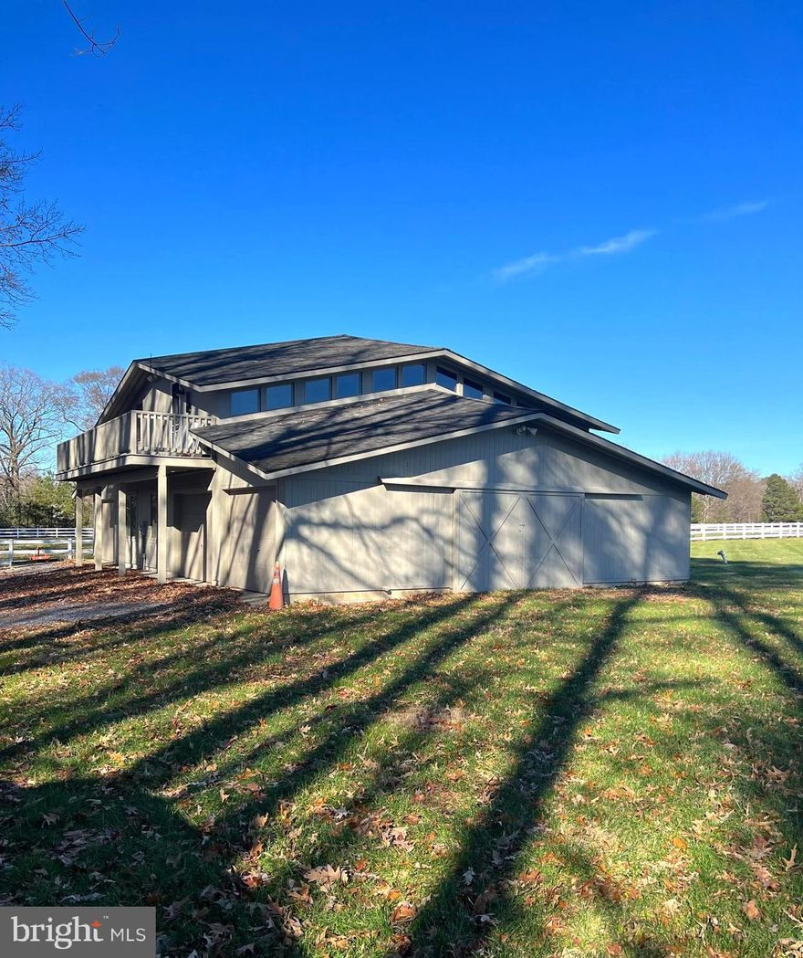 This majestic 8.5 acre lot hosts the 2 story barn styled after the main house. It includes 3 parking spaces with operable doors, three stalls, a wash stall, and a feed stall.  On the second floor is a 2 bedroom, 1 bath apartment. In addition to the barn, there is a large paddock with two separate areas separated by a fence and a turnout shed that can be entered from either side of the paddock.  This lot has 4 feet MLW at the end of the dock. The apartment is being offered unfurnished but there is a washer/dryer included. Please do not drive up lane without an appointment.
(10205 Kintore Drive (main house and entire property) is currently listed for sale in MLS and is NOT for rent. Apartment for rent only)