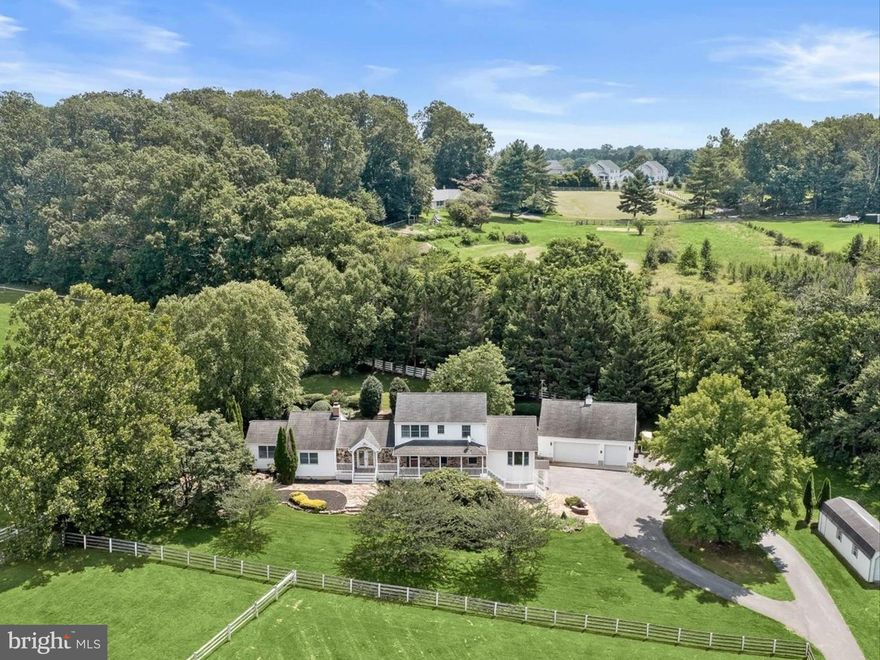 Welcome to 1955 Valhalla Drive, a breathtaking 25-acre horse farm tucked away at the end of a long private driveway in a peaceful, secluded setting. This exceptional property offers the perfect blend of equestrian functionality and refined residential living. 

The farm features a gorgeous 10-stall barn with attached individual runs for each stall and infrastructure in place to expand to 13 stalls as three stalls are oversized. The thoughtful equestrian amenities include a wash stall with hot and cold water, a heated lounge and tack room, ample loft storage, and custom lockers. The indoor arena features a custom blend of rubber and sand footing, LED lighting, mirrors, and viewing stands perfect for hosting clinics or teaching lessons. The climate-controlled lounge in the barn offers a warm gathering space with oak cabinetry, a kitchenette, and vinyl flooring.  Additionally, there is a separate feed room with custom cabinetry and shelving and multiple equipment and hay storage nooks carefully placed in the barn for ease of care of the horses on a daily basis. Additionally, there is a bathroom with full laundry in the barn perfect for clients and guests, and an incredible amount of storage for barn equipment, tractors, and hay as well .  Need extra stalls?  There is plenty of room to expand either by converting the three oversized stalls or adding stalls in the storage area attached to the main barn.  See the included floor plans for measurements and possibilities. The barn operates on a separate electric meter and is served by its own well and septic system. The property also includes multiple storage sheds and safely fenced pastures each with run-in sheds surrounded by a combination of wood and vinyl fencing and a full size 20 x 60 meter sand outdoor riding arena, making it ideal for both casual and competitive equestrian pursuits.  

The custom-built 5 bedroom, 3 full and 2 half bath home offers nearly 5,000 square feet of living space with fresh neutral paint throughout.  The kitchen is designed for everyday living and entertaining, offering ample cabinetry, dual wall ovens, a large five-burner Kenmore range, and stunning views of the pastures. A spacious great room with vaulted wood ceilings sits just off the kitchen and offers access to the mud room, while a separate large living room with vaulted wood ceilings and a wood-burning fireplace provides a warm and welcoming gathering space. The first-floor primary suite features a large custom dressing room and a spa-like en suite bath with dual vanities and a custom tile shower. The first-floor laundry room with storage adds everyday convenience. The unfinished basement includes a powder room and several additional rooms that can easily be converted into a home office, gym, or home theater.

Upstairs, you’ll find four additional bedrooms, including a junior suite with an en suite bath and walk-in closet. A secondary full bath is located off the hall and serves the other three bedrooms. One of the upstairs bedrooms includes a built-in sink, and was previously an art studio, offering flexible space that can be repurposed to suit your needs. 

Outside, the home is flanked by gorgeous perennial gardens, a large two story detached three car garage, a charming wooden bridge to the barn, and manicured lawns as well as a large rear deck and patio with a grilling station. Xfinity internet serves the home and barn ensuring connectivity.

This is a rare opportunity to own a fully appointed, private equestrian estate with such attention to detail and meticulous care. Whether you’re a professional equestrian seeking a permanent base of operations, a discerning competitor looking for top tier accommodations for you and your show horses, or someone simply looking for peaceful country living with luxurious farm amenities, 1955 Valhalla Drive has so much to offer. 

Shown by private appointment only.  Please no drive bys. Sale includes two parcels and totals 25.38 acres.