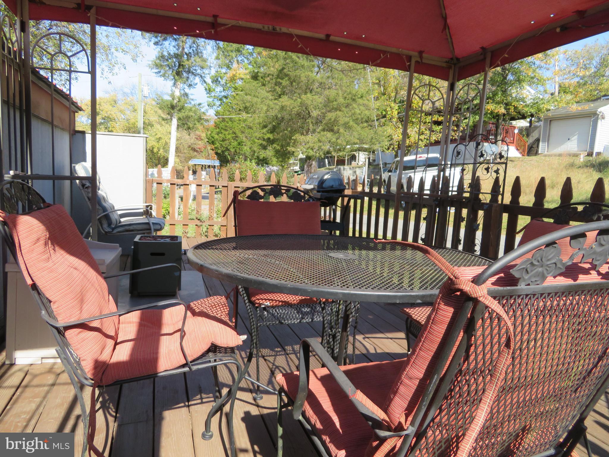 PRICE REDUCED!! MOTIVATED SELLER!! BRING YOUR OFFER AND enjoy camping season in this turnkey seasonal getaway in Riverbend RV Park! This 2400 sq foot lot features a deck, canopy, propane fire place, outdoor table/chairs, grill, EZ GO gas golf cart, dirt bike, & shed with electric. The RV & addition comes furnished with sleeping for 6, lots of storage, a full bathroom, 2 window A/C units and much more. Metal Roof was installed in 2011. Riverbend RV Park has private Potomac River access for boating, fishing & swimming. Riverbend RV Park's yearly membership includes water, sewer, electric, trash and the park amenities such as pools, putt putt, basketball court, tennis court, holiday fireworks for July 4th, car show, carnival, restaurant, playground, ball field and much more. Riverbend RV Park is located close to shopping, I81 & The C&O Canal for hiking & biking. Own this getaway in as little as 3 weeks. Call today before it's gone! **Gated community-pass required for entry. **Riverbend sales are SOLD "AS IS", CASH only and seasonal.** (Direct TV and Frontier Internet available with service install/hookup).