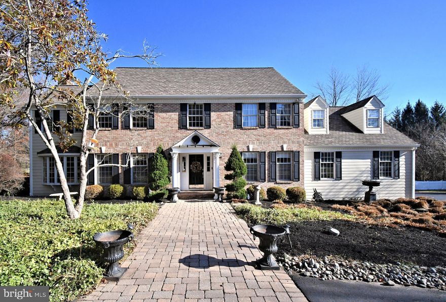 Nestled in a peaceful cul-de-sac on 3.4 acres, this stunning brick front colonial welcomes you with a long driveway that leads to a graceful circular drive surrounded by lush landscaping. This home offers exceptional space, beginning with formal living and dining rooms and flowing into a beautifully remodeled kitchen with large center island, cozy breakfast area and wood burning fireplace. A bright sunroom an a large family room also featuring a wood fireplace provide inviting spaces to relax, while an impressive great room showcases custom bookshelves and its own wood burning fireplace. French doors open to a custom deck overlooking an inground pool, pond and professional landscaping.  Perfect for entertaining or quiet evenings outdoors. With a full bath and dedicated office space on the main level, plus a 3 car garage On the second level, a grand turned staircase leads to a luxurious primary bedroom, complete with a cozy sitting room and a beautifully remodeled bath featuring a whirlpool tub and a separate shower, along with ample closet space.  The upper floor also includes 3 additional bedrooms and a remodeled hall bath.  The home also boasts a full basement with a separate laundry room, adding even more convenience and functionality to this exquisite home. This home blends elegance and comfort in a truly special setting!