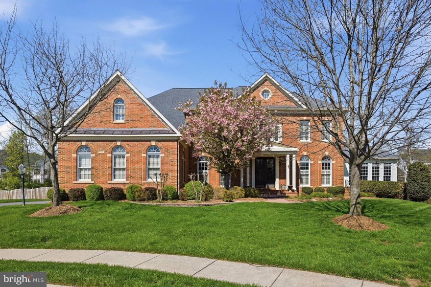 Welcome to this stunning and breathtaking Langley model, ideally situated in a cul-de-sac in the sought-after South Village section of South Riding, located in Loudoun County. This exceptional home is truly unmatched, offering extensive upgrades throughout both the interior and exterior.

From the moment you arrive, the custom brick walkway and double glass door entry set the tone for the elevated design found throughout. Inside, the home is filled with beautiful natural light and showcases hand-scraped flooring across the main and upper levels, along with thoughtfully curated finishes.

The expansive two-story family room is the heart of the home, featuring a coffered ceiling with recessed lighting, a wall of arched windows, and a central fireplace that anchors the space. The open layout provides seamless flow for both everyday living and entertaining.

The gourmet kitchen is designed for those who love to cook and gather, showcasing premium Monogram, Wolf, and Miele appliances, including a built-in espresso system. An oversized Carrera marble island offers additional seating and prep space, complemented by custom lighting, under-cabinet lighting, a walk-in pantry, and a butler’s pantry that can be used as a bar or coffee station.

Upstairs, you’ll find four oversized bedrooms, including a beautifully updated owner’s suite with a sitting area, a large walk-in closet, and a spa-inspired bath featuring an oversized shower, soaking tub, and private water closet. The owner’s suite also features a private deck, perfect for enjoying quiet mornings or unwinding in the evening.

One secondary bedroom offers its own private en-suite bath, while the remaining two bedrooms are connected by a well-appointed Jack and Jill bathroom. All secondary bedrooms offer generously sized closets.

The fully finished walk-up lower level is ideal for entertaining, featuring custom epoxy flooring, surround sound, a custom bar with upgraded lighting, a full bedroom and bath, and ample space for recreation or a private retreat.

Outdoor living is elevated like no other. The private, tree-lined backyard creates a breathtaking setting, featuring a custom pool and hot tub surrounded by imported travertine tile. A custom gazebo with stone fireplace and built-in bar enhances the experience, while multiple outdoor living areas include tri-level decking, a deck off the kitchen overlooking the pool, and a screened-in all-season deck with wood flooring. The yard is complete with custom landscaping and a partial wood and wrought iron fence.

Residents of South Riding enjoy an exceptional array of amenities, including multiple pools, tennis courts, playgrounds, playing fields, and miles of wooded and paved walking trails. Close by, you’ll also find a walking trail, a park with a soccer field, basketball court, and a tot lot with bench seating, perfect for enjoying time outdoors.

Additional features include a three-car garage with epoxy flooring, ample parking, a spacious mudroom with powder room access, plantation shutters, custom drapery, and designer lighting throughout. This home offers a rare combination of luxury, privacy, and exceptional indoor-outdoor living in one of Loudoun County’s premier communities. Photos may be virtually staged