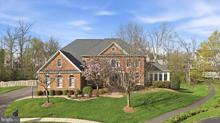 Welcome to this stunning and breathtaking Langley model, ideally situated in a cul-de-sac in the sought-after South Village section of South Riding, located in Loudoun County. This exceptional home is truly unmatched, offering extensive upgrades throughout both the interior and exterior.

From the moment you arrive, the custom brick walkway and double glass door entry set the tone for the elevated design found throughout. Inside, the home is filled with beautiful natural light and showcases hand-scraped flooring across the main and upper levels, along with thoughtfully curated finishes.

The expansive two-story family room is the heart of the home, featuring a coffered ceiling with recessed lighting, a wall of arched windows, and a central fireplace that anchors the space. The open layout provides seamless flow for both everyday living and entertaining.

The gourmet kitchen is designed for those who love to cook and gather, showcasing premium Monogram, Wolf, and Miele appliances, including a built-in espresso system. An oversized Carrera marble island offers additional seating and prep space, complemented by custom lighting, under-cabinet lighting, a walk-in pantry, and a butler’s pantry that can be used as a bar or coffee station.

Upstairs, you’ll find four oversized bedrooms, including a beautifully updated owner’s suite with a sitting area, a large walk-in closet, and a spa-inspired bath featuring an oversized shower, soaking tub, and private water closet. The owner’s suite also features a private deck, perfect for enjoying quiet mornings or unwinding in the evening.

One secondary bedroom offers its own private en-suite bath, while the remaining two bedrooms are connected by a well-appointed Jack and Jill bathroom. All secondary bedrooms offer generously sized closets.

The fully finished walk-up lower level is ideal for entertaining, featuring custom epoxy flooring, surround sound, a custom bar with upgraded lighting, a full bedroom and bath, and ample space for recreation or a private retreat.

Outdoor living is elevated like no other. The private, tree-lined backyard creates a breathtaking setting, featuring a custom pool and hot tub surrounded by imported travertine tile. A custom gazebo with stone fireplace and built-in bar enhances the experience, while multiple outdoor living areas include tri-level decking, a deck off the kitchen overlooking the pool, and a screened-in all-season deck with wood flooring. The yard is complete with custom landscaping and a partial wood and wrought iron fence.

Residents of South Riding enjoy an exceptional array of amenities, including multiple pools, tennis courts, playgrounds, playing fields, and miles of wooded and paved walking trails. Close by, you’ll also find a walking trail, a park with a soccer field, basketball court, and a tot lot with bench seating, perfect for enjoying time outdoors.

Additional features include a three-car garage with epoxy flooring, ample parking, a spacious mudroom with powder room access, plantation shutters, custom drapery, and designer lighting throughout. This home offers a rare combination of luxury, privacy, and exceptional indoor-outdoor living in one of Loudoun County’s premier communities. Photos may be virtually staged