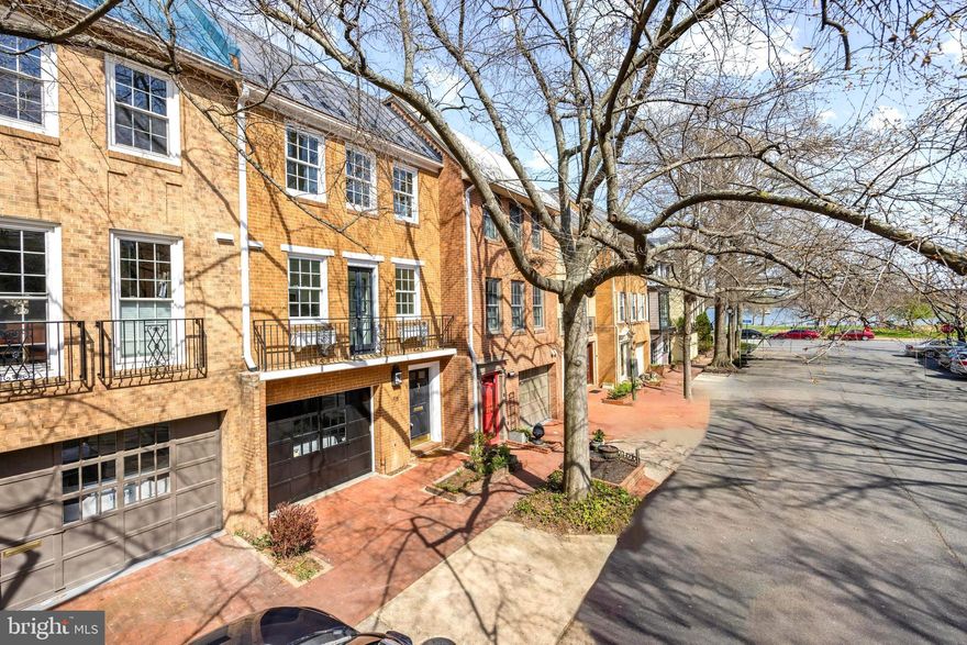 Welcome to 115 Princess Street, where quintessential Old Town charm meets unparalleled convenience in this highly sought after location. This solid brick residence offers Potomac River views from the kitchen and is just steps to Waterfront Founders Park & just 10 minutes to DC and National Airport. Surrounded by greenspaces and just blocks to dozens of restaurants and shopping.  A spacious fenced backyard provides a serene retreat and plenty of room for entertaining. The interior features two large bedrooms, each with its own full bath,  a den with half bath, an open floorplan with dining room and living room with 11-foot ceilings and fireplace. French doors off the living room open onto a private stone patio. The backyard offers a tranquil oasis for relaxation and entertaining. The kitchen features french doors leading to a  balcony with refreshing breezes and delightful waterviews .

Hardwood floors throughout all 3 levels and 2 fireplaces. The stand up attic offers easy expansion and can be configured with steps for additional living space.

With two parking spaces, including a one-car garage and driveway parking, convenience is at a premium. Whether enjoying a leisurely stroll along the waterfront, exploring the bustling King Street district, or hopping on the Trolly to the nearby metro, this home offers the ultimate escape in the heart of it all.