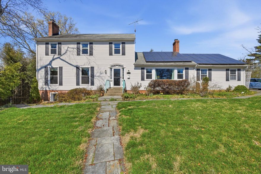 A sweeping lawn and stone pathway lead to a light-filled, center-hall Colonial with 4,111 sqft of beautifully livable space. Upgrades include oversized ceramic marble tile, newly refinished hardwoods, energy-efficient double-paned windows, a new electrical panel with updated service wiring, and enhanced lighting throughout. Solar roof panels add long-term efficiency.

The updated kitchen features new appliances and granite countertops, flowing seamlessly to a formal dining room with custom built-ins and a spacious great room with patio access and rare two-car garage entry. A front room with dual French doors serves as a private study, with an additional built-in office off the dining area offering elegant flexibility for work or guests.

Upstairs, four bright bedrooms include a generous primary suite with oversized closet and ensuite bath. Both baths have been fully redesigned with double vanities, and a thoughtfully integrated laundry area adds everyday convenience.

The lower level offers a self-contained suite with bedroom, den, full kitchen with granite and gas oven, dining area, second laundry, and private entrance to a lower patio with fire pit and fully fenced yard.

Over $60,000 in curated landscaping, on an 11,326 sqft lot, features two tiers of flagstone patios, a terraced retaining wall, bamboo privacy screen backing to the park, and person-height Limelight hydrangeas. With more than $200,000 invested, proximity to Rock Creek Park, Metro, and the forthcoming Purple Line, this is a rare opportunity in one of the area's most established neighborhoods. Enjoy all the Chevy Chase perks for Silver Spring prices!