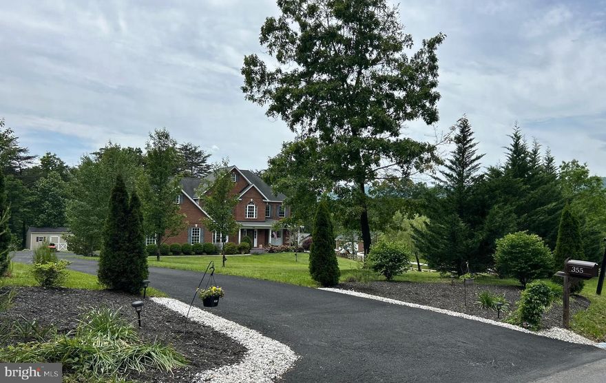 Experience the epitome of homeownership with this stunning colonial home property perfectly set on 2.5+ acres of serene land just moments from all the conveniences of town. Offering the perfect blend of classic charm and modern amenities, this home is ideal for those seeking privacy without sacrificing accessibility. Thoughtfully designed with generous living spaces. Upon entering, you're greeted by a grand 2-story foyer creating a bright and airy atmosphere with hardwood floors. The spacious yet inviting living area is anchored by a cozy fireplace with a stunning stone surround hearth and offers tranquil views of the backyard and north mountain. The open-concept kitchen is an entertainer's dream, seamlessly flowing into the living area with its granite countertops, 42 in cherry wood cabinets and gleaming stainless appliances, making it perfect for gatherings and casual meals, with a breakfast area that adds charm. The foyer and formal dining room features elegant wainscoting along with the master bedroom having coved ceiling. Multiple large bedrooms, including a luxurious main floor primary suite with two walk in closets and large en suite with double sinks, shower and a jetted tub. Three additional well-sized bedrooms upstairs providing plenty of room including another master suite with double sinks and walk in closet. Welcome the sunlight each morning to providing privacy and comfort each night, with custom fit Levolor blinds in every window. Each closet features custom-built wooden shelving with lights designed for optimal organization and storage. The home also includes an expansive walk out unfinished basement, offering unlimited potential for additional living space, allowing for future customization and added value. Enjoy the convenience of a newly sealed and paved driveway offering ample parking for multiple vehicles, perfect for families or those with guests.  The extra space allows for comfortable parking and extra room for recreational equipment. The property also includes a spacious two-car attached garage with epoxy floors and gleaming white walls. Need extra storage? This property includes a functional 12x24 storage shed, providing a dedicated space for tools, lawn equipment, or anything else that needs a home.  Enjoy the benefit of a well-organized outdoor space. This home features a whole-house generator, providing peace of mind and uninterrupted power during outages. Enjoy the custom security alarm system along with automated dawn to dusk floodlights in each corner of the property.Imagine days and evenings spent swinging and relaxing on the front covered brick porch or the low maintenance back deck and lovely patio enjoying the hot tub and the natural beauty of your surroundings and magnificent wildlife. Discover the magic of this home, where towering oaks and pines and weeping willow frame the property, along with a small pond creating a picturesque setting. The landscape is a masterpiece of design, featuring a variety of colorful flowers and neatly trimmed hedges. The mature trees provide shade and privacy, while the well-maintained lawn invites you to relax and enjoy the outdoors. The huge yard offers an ideal space for pets to roam freely, as well as plenty of room for gardening and outdoor activities. With a spacious layout, stylish features, and fresh paint it’s ready for you to move in and enjoy.Don't miss this rare opportunity to own your dream home, where you can live, grow, and thrive just minutes from downtown Winchester.