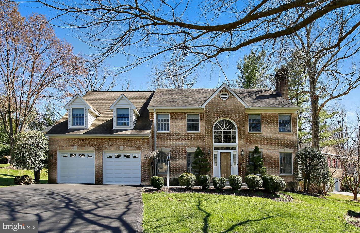 Stunning brick colonial with attached, two-car garage in Quince Orchard Knolls! A dramatic two-story foyer is enhanced by a massive arched window above the front door, letting in plenty of natural light. The formal living room has a fireplace with dentil molding, and the formal dining room has picture frame molding and two large bay windows. The huge kitchen has an L-shaped center island with cooktop and space for bar stools, as well as under-counter storage for trash bins. Enjoy breakfast in the wood-paneled sunroom with skylights, vaulted ceiling, and a lush view from every angle. This leads to a flagstone, screened-in patio, where you're sure to enjoy many meals this spring and summer! The family room has an inviting stone fireplace with hexagonal windows, and there's an office with built-in shelving, perfect for those who work from home. The laundry room is also on the main level. Upstairs are four sunny and generously sized bedrooms and three baths. The massive primary suite with two dormers and a vaulted ceiling offers a marble fireplace, separate sitting room, nursery, or office, and a custom walk-in closet with enough space for two wardrobes. Schedule a tour of this beautiful property today!