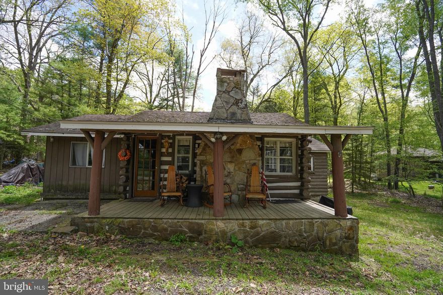 Step back in time to this original Deep Creek Lake cottage at 619 Beckmans Peninsula Road! This 1947 built log cabin offers original chestnut log construction with white chinking, a classic for homes of this era. Check out the lake views and watch the sunset from the covered porch.The oversize, natural stone fireplace creates an ambiance for those chilly spring, fall or winter days. Original hardwood floors captivate the main living area of the cabin. 2 full bedrooms and 1 full bathroom. An extra storage space off the kitchen could be utilized as a 3rd bedroom. Beckmans Peninsula is a highly coveted area of the lake that will give you the relaxing feel you've been waiting for! Call today to schedule a time to see this original DCL cottage! This one won't last long!