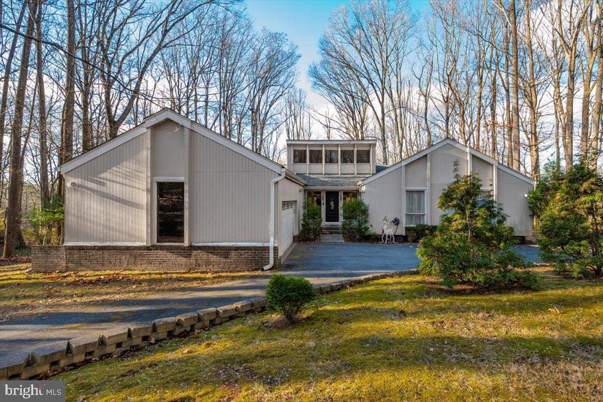 Welcome to 10101 Lloyd Road. Nestled on a private 1.32-acre wooded lot in one of the most desirable neighborhoods of Potomac, this beautiful mid-century residence offers the perfect blend of timeless design, modern comfort, and exceptional space. Boasting nearly 4,000 square feet of living space, this beautifully maintained home features 5 spacious bedrooms with 8-ft ceilings and 3 fully upgraded bathrooms, providing plenty of room for family living, guests, and work-from-home flexibility. At the heart of the home is a gourmet kitchen designed for both everyday living and entertaining, complete with generous prep space and seamless flow into the home’s inviting living and dining areas. A sliding glass door opens from the kitchen to a spacious outdoor deck, creating the perfect setting for morning coffee, grilling, and effortless indoor-outdoor dining. The living room offers another wonderful connection to nature, with direct access to a second expansive deck, ideal for relaxing, hosting gatherings, or enjoying peaceful views of the surrounding woods. Large windows throughout the home bring in abundant natural light and frame serene, wooded views, creating a tranquil retreat just minutes from everything. The fully finished lower level expands the living space even further, featuring sauna and versatile areas ideal for recreation, fitness, or entertainment. Outside, the 1.32-acre lot provides exceptional privacy with mature trees and natural landscaping—perfect for outdoor gatherings, quiet relaxation, or simply enjoying the beauty of the wooded setting from either of the home’s generous decks. Located in a highly sought-after community known for its top-rated schools, this rare Potomac mid-century gem combines space, privacy, and convenience just minutes from shopping, dining, and major commuter routes.