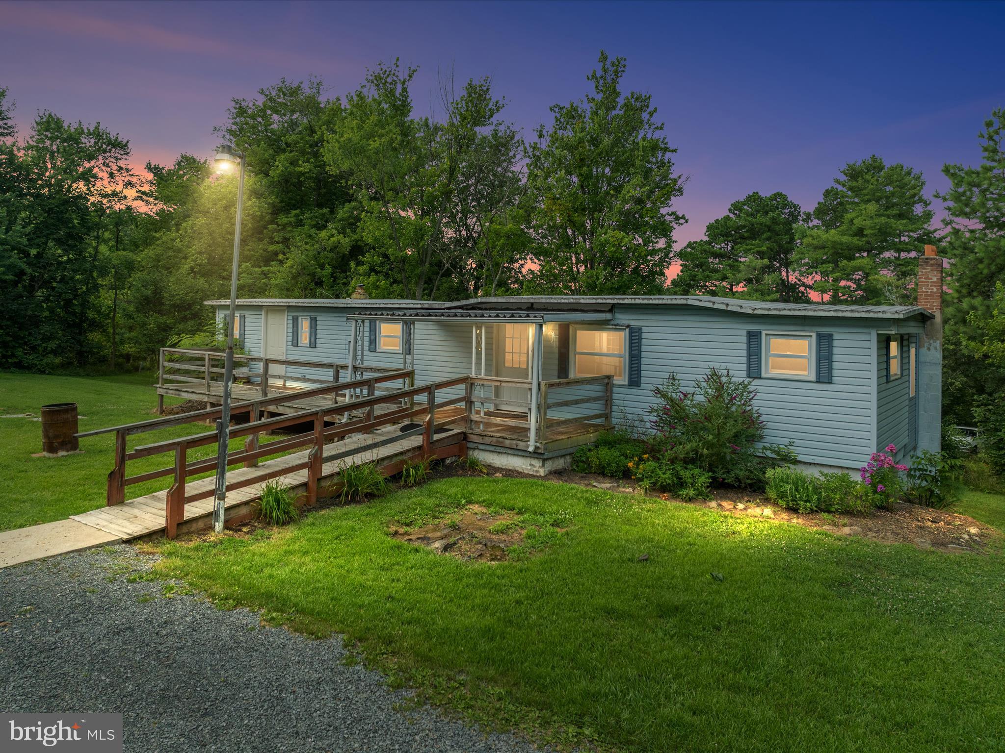 Welcome to 123 Old Bethel Ln – a spacious manufactured home situated on a beautiful lot that may exceed tax-recorded acreage (buyer to verify with survey). This property has served as a long-time family home and is now ready for a new chapter—offering affordability, space, and potential. The home includes multiple living areas, intact appliances, some updated windows, and a layout that could be renovated room by room. Accessibility features are already in place, and the property includes a shed and gently sloping lawn bordered by mature trees and bushes. The septic system has been pumped and serviced in the last two years, and the well is equipped with a newer pressure tank and pump. The structure sits on a full basement—giving you options to renovate, rebuild, or even remove the existing double wide and place a new home on the solid foundation. Either way, you'll be working with a great lot, established utilities, and room to build value. Please note: the home has been well-loved but not recently updated and will not qualify for traditional financing. Some ceilings show signs of past water intrusion, the basement has a musty odor, and the back deck is unsafe to walk on—do not step on it during your visit. The home is a 1988 time capsule in many ways, and while it needs work, it carries the warmth and pride of long-term ownership. It is being sold strictly as-is and is priced accordingly. 123 Old Bethel Ln is an affordable opportunity with a strong foundation—literally and figuratively—for those ready to put in the work. Whether you’re an investor or a handy buyer looking for space, structure, and value, this one is worth a closer look.
