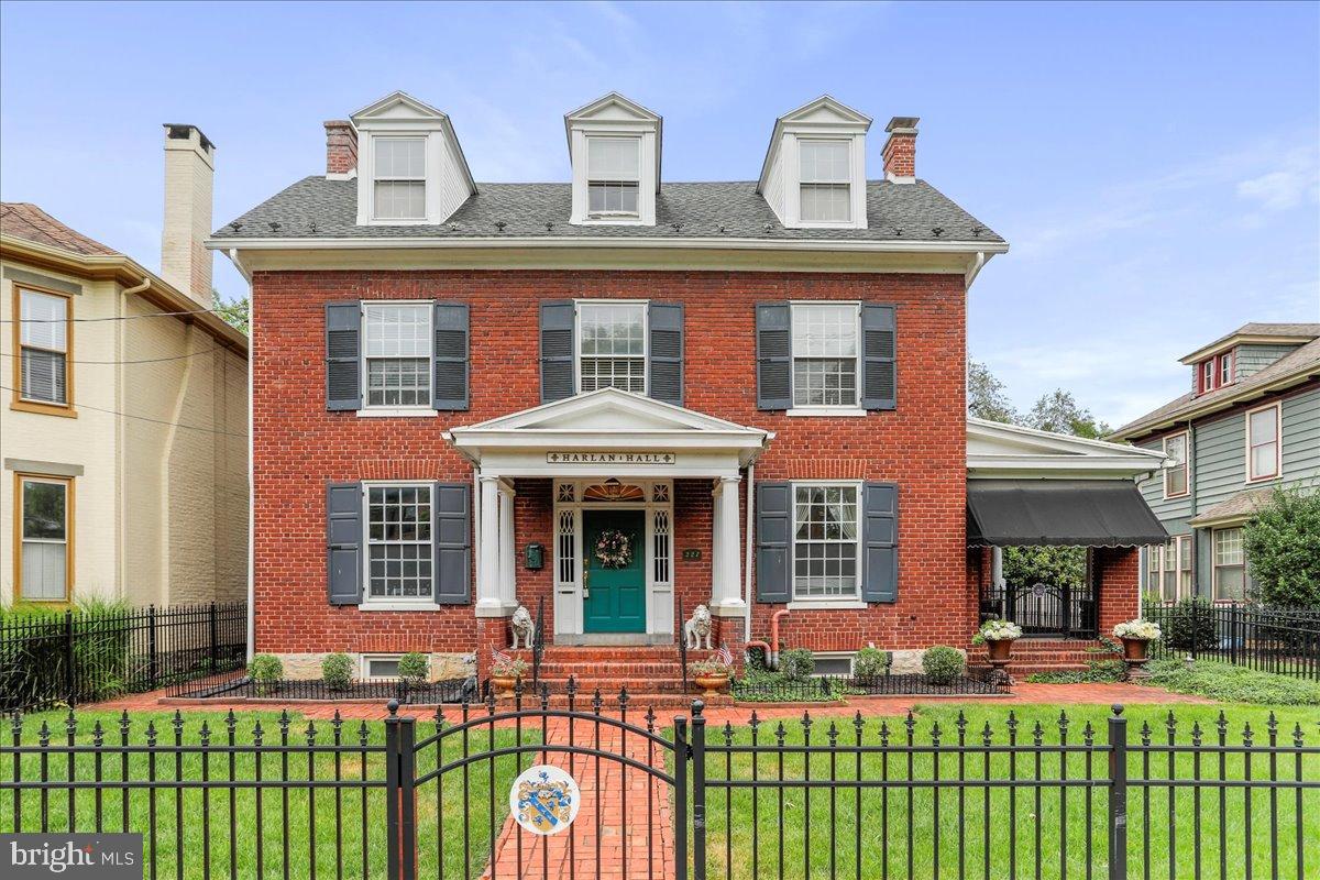 Step into this exquisite brick Colonial built in 1915 and experience the perfect blend of historic character and modern convenience. Located in the heart of Chambersburg, this one-of-a kind home offers timeless craftsmanship, stunning details and unique living spaces you won't find anywhere else. As you enter through the front door with transom window and sidelights, you're welcomed by a grand foyer with beautiful hardwood floors that continue throughout much of the home. The formal living room is both elegant and inviting, featuring rich moldings, a gas fireplace and direct access to a gorgeous, covered side porch-ideal for relaxing or entertaining. The formal dining room echoes the home's classic charm with beautiful hardwood floors, intricate moldings and a plate rail for added character. The kitchen is a showstopper with a replica cookstove, copper-like backsplash, stained glass window, tin ceiling and an original built-in hutch for extra storage. A butler's pantry, which also serves as the laundry room, sits between the kitchen and dining room. The kitchen also leads to a cozy mudroom and out to the backyard oasis. The fully fenced in rear yard is a true retreat-complete with a koi pond and waterfall, a charming fountain, pergola, hot tub hookup, covered patio with porch swing and ceiling fan, and a pathway leading to the charming one car detached garage and additional parking. Upstairs, you'll find three uniquely charming bedrooms, a cozy sitting room and a full bath. The primary offers double closets and built-ins. One of the bedrooms offers access to a private balcony. The third level features a fully equipped and furnished in-law suite, complete with kitchen, living room, bedroom and full bath. As you enter the third level/in-law suite, you will immediately notice the gorgeous windows complete with cedar lined window seats! The eat-in kitchen is fully equipped and even has a sky light and copper range hood! The bedroom and bath both have French doors to ensure privacy. This is the perfect space for extended guests! The lower level includes a workshop, ample storage and a one-of-a-kind fallout shelter/bunkroom with six built-in bunk beds! This home is conveniently located near WellSpan Chambersburg Hospital, I-81 and all the amenities of downtown Chambersburg. This truly special home offers character, space and location-all in one package. Come see the charm and possibilities this timeless Colonial has to offer! Room sizes and square footage are estimated.
