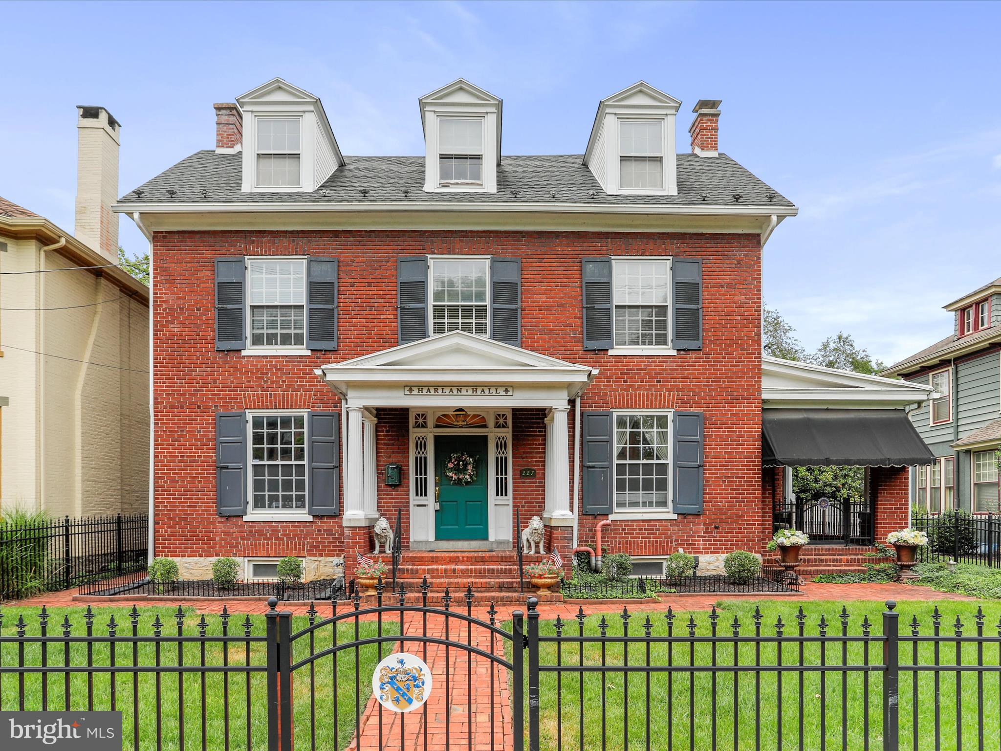 Step into this exquisite brick Colonial built in 1915 and experience the perfect blend of historic character and modern convenience. Located in the heart of Chambersburg, this one-of-a kind home offers timeless craftsmanship, stunning details and unique living spaces you won't find anywhere else. As you enter through the front door with transom window and sidelights, you're welcomed by a grand foyer with beautiful hardwood floors that continue throughout much of the home. The formal living room is both elegant and inviting, featuring rich moldings, a gas fireplace and direct access to a gorgeous, covered side porch-ideal for relaxing or entertaining. The formal dining room echoes the home's classic charm with beautiful hardwood floors, intricate moldings and a plate rail for added character. The kitchen is a showstopper with a replica cookstove, copper-like backsplash, stained glass window, tin ceiling and an original built-in hutch for extra storage. A butler's pantry, which also serves as the laundry room, sits between the kitchen and dining room. The kitchen also leads to a cozy mudroom and out to the backyard oasis. The fully fenced in rear yard is a true retreat-complete with a koi pond and waterfall, a charming fountain, pergola, hot tub hookup, covered patio with porch swing and ceiling fan, and a pathway leading to the charming one car detached garage and additional parking. Upstairs, you'll find three uniquely charming bedrooms, a cozy sitting room and a full bath. The primary offers double closets and built-ins. One of the bedrooms offers access to a private balcony. The third level features a fully equipped and furnished in-law suite, complete with kitchen, living room, bedroom and full bath. As you enter the third level/in-law suite, you will immediately notice the gorgeous windows complete with cedar lined window seats! The eat-in kitchen is fully equipped and even has a sky light and copper range hood! The bedroom and bath both have French doors to ensure privacy. This is the perfect space for extended guests! The lower level includes a workshop, ample storage and a one-of-a-kind fallout shelter/bunkroom with six built-in bunk beds! This home is conveniently located near WellSpan Chambersburg Hospital, I-81 and all the amenities of downtown Chambersburg. This truly special home offers character, space and location-all in one package. Come see the charm and possibilities this timeless Colonial has to offer! Room sizes and square footage are estimated.