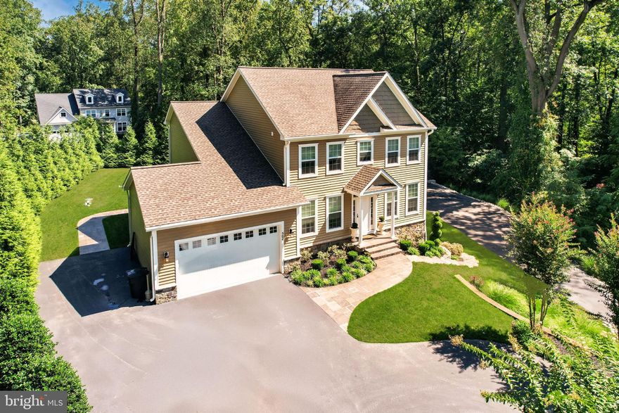 Nestled within the serene enclave of Severn Landing, this exquisite Colonial residence offers a harmonious blend of luxury and comfort, set on a sprawling 1.44-acre lot that backs to lush trees, providing a tranquil retreat from the everyday hustle. Built in 2016, this home boasts over 4,000 square feet of thoughtfully designed living space, perfect for both entertaining and everyday living. Step inside to discover a warm and inviting interior adorned with elegant crown moldings and recessed lighting that enhance the ambiance throughout. The heart of the home is the gourmet kitchen, featuring upgraded granite counter tops, new appliances, and a spacious island that invites culinary creativity. The main level also includes a formal dining area, ideal for hosting dinner parties, and a convenient half bath for guests. Off the foyer is a main level office / sitting room for whatever fits your needs. Ascend to the upper level to find four generously sized bedrooms, including a luxurious primary suite complete with a walk-in closet and a spa-like bathroom featuring a soaking tub and separate shower-your personal sanctuary for relaxation. The fully finished basement offers additional living space, complete with a walkout entrance, making it perfect for a home theater, gym, or guest suite. With ample storage this space is as functional as it is stylish. Outside, the property shines with meticulously landscaped grounds, featuring a spacious deck and patio that beckon for al fresco dining and summer gatherings. The expansive yard provides plenty of room for outdoor activities, while the paved circular driveway leads to both an attached 2-car garage and a detached 4-car garage, offering abundant parking and storage options. The 24 x 42 conditioned detached garage boasts drywall, high ceilings, and a "negotiable" vehicle lift. For those who appreciate water activities, this home provides private access to navigable waters, perfect for boating, fishing, or kayaking. Enjoy the community's amenities, including a pier for easy water access, a sandy beach, 2 tot lots and a pavilion area overlooking the scenic Severn River. This residence is not just a home; it's a lifestyle choice that embodies luxury, comfort, and the beauty of nature. Experience the perfect blend of elegance and functionality in this remarkable property, where every detail has been crafted for your enjoyment.