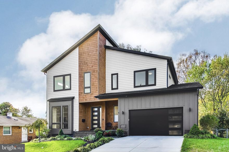 Discover modern elegance in this exceptional contemporary custom-built home in the Town of Vienna, boasting 5 spacious bedrooms and 4.5 stylish bathrooms, where sophisticated design meets unparalleled functionality. The striking facade combines James Hardie plank, board and batten siding, and cedar siding, while large windows create a seamless connection between indoor and outdoor living spaces - perfect for both entertaining and relaxation.  As you approach, the beautifully landscaped front garden and inviting covered stone porch set the stage for the extraordinary experience that awaits within. 
This stunning interior showcases an open, sun-drenched floor plan that exudes warmth and brightness. The main level features a dedicated office space, perfect for work or study, alongside a chic powder room. The mudroom features shiplap walls that create a bright and airy atmosphere, built-in storage, and a utility sink, providing an organized and welcoming entryway for your belongings. The living room captivates with its beautiful accent wall and a cozy gas fireplace, creating a lovely focal point. This inviting space seamlessly flows into a screened-in porch - a perfect oasis for indulging in the beauty of nature while enjoying a protected retreat from the elements. The dining area is distinguished by a remarkable wall of windows that provides views of the serene backyard and also has direct access to the screened-in porch. The gourmet kitchen is crafted with meticulous attention to detail. It features a walk-in pantry, custom Wellborn cabinets in a crisp white finish, and a spacious island that is the perfect centerpiece for casual gatherings and culinary adventures. The quartz countertops and tile backsplash enhance the design, while under-cabinet lighting beautifully illuminates the workspace. Floating shelves add a charming touch, offering the perfect display for your favorite decor or cookbooks. 
Ascend to the upper level, where you will find a spacious and luxurious primary bedroom suite. This retreat features a generously sized walk-in closet and a spa-inspired bathroom, complete with stunning custom tiling, a large picture window, a relaxing jetted soaking tub, a shower with a rainfall showerhead, and separate sink vanities, providing ample space for daily routines. Three additional sizable bedrooms, including one with an en-suite bathroom for added privacy, while two others share a charming Jack and Jill bathroom with two vanities. For added convenience, a well-appointed laundry room has sleek cabinetry and a granite countertop with a leather finish.
The lower walkout level features LVP flooring, accentuating the spacious rooms, including a recreation room designed for relaxation and leisure, an exercise area, and a vibrant game zone complete with a wet bar, making it perfect for entertaining. Additionally, this area includes a fifth bedroom, providing a cozy retreat for your guests, along with a semi-ensuite full bathroom. The recreation room opens to a delightful screened-in patio, creating an ideal space to enjoy the outdoors while overlooking the beautifully manicured backyard. Experience the charm of nearby downtown Vienna, where picturesque, tree-lined streets invite you to explore a delightful array of local shops, restaurants, and lush parks. Enjoy outdoor activities in the scenic parks and along the inviting W&OD Trail. Throughout the year, you can participate in a vibrant range of community events. Additionally, with easy access to the Metro Stations and major roadways such as I-66, I-495, the Express Lanes, Route 7, and Route 123, commuting and traveling to surrounding areas is convenient. Embrace the perfect blend of luxury and comfort in this exceptional contemporary home, ideally situated in the heart of Vienna!