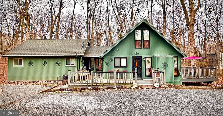 Beautiful Chalet in the desirable Woods Resort! Popular Elmwood style home on a private 1-acre wooded lot - 2 bedrooms, open floor plan, living room with floor to ceiling windows and a cozy woodstove, and a huge multi-purpose room that provides wonderful opportunities for additional bedrooms or a family/rec room (currently used as a music studio). Gorgeous knotty pine ceilings and engineered hardwood floors throughout the main living areas. The unfinished basement provides tons of storage space. Plenty of space to enjoy the outdoors with the screened in porch area, the wraparound porch, side deck, rear Trex deck, and the lovely fenced in yard. The Woods Resort spans over 1,800 acres of lush forests and rolling hills, perfect for relaxation or outdoor enthusiasts and is known most for its spas and golf course.