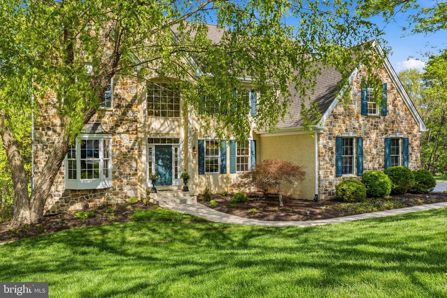 Nestled at the end of a private cul-de-sac in the prestigious Cherry Creek Conservation Community, this exceptional custom-built luxury residence offers 6 bedrooms, 4 full baths, 1 half bath, a finished walk-out lower level, and multiple flex spaces across more than three expansive levels of living space. Set on a beautifully landscaped .6-acre lot backing directly to protected woodlands and scenic walking trails, the property enjoys complete backyard privacy with no visible rear or side neighbors. Built in 2004 with timeless architecture and exceptional craftsmanship, the home showcases authentic Pennsylvania field stone, steep-pitched rooflines, premium Andersen windows and doors, Brazilian cherry hardwood flooring, soaring ceilings, extensive custom millwork, elegant architectural archways, and abundant natural light throughout.
The dramatic two-story foyer with a grand butterfly staircase opens to elegant formal living and dining rooms, while the breathtaking family room showcases vaulted ceilings and a floor-to-ceiling Pennsylvania field stone fireplace framed by oversized windows with arched transoms. A private first-floor office provides the ideal work-from-home setup.
Designed for both everyday living and entertaining, the gourmet kitchen features Perla Cream Century cabinetry, Uba Tuba granite countertops, stainless steel appliances, double wall ovens, a five-burner cooktop with decorative grotto hood, oversized center island, pantry, secretary station, and spacious breakfast area overlooking the private rear yard. A functional mudroom includes a laundry area and dedicated dog wash station.
Upstairs, the luxurious owner’s suite offers a stepped tray ceiling, separate sitting room or secondary office, dual walk-in closets, and a spa-inspired bath complete with soaking tub, oversized tiled shower, dual vanities, and peaceful woodland views. Four additional generously sized bedrooms complete the upper level, including a Jack-and-Jill suite and an additional hall bath.
The finished walk-out lower level dramatically expands the home’s versatility with a custom wet bar, theater room, marble-floored second family room, private sixth bedroom or in-law suite with full spa bath, plus an additional flex room ideal as a potential guest room, gym, hobby or art studio, playroom, or second office. With nine full-size windows and direct outdoor access, the lower level lives like an additional main floor.
Outdoor living is equally impressive, featuring an expanded rear deck with spa-style seating, beautifully landscaped walk-out patio, stone retaining walls, custom fire pit, colorful gardens, and an expansive flat backyard surrounded by mature trees.
Located within the award-winning West Chester Area School District, including Bayard Rustin High School, and just minutes from West Chester Borough, the Main Line, Philadelphia International Airport, tax-free Delaware shopping, and major commuter routes including Routes 202, 1, 322, and I-95, this extraordinary home combines luxury, privacy, flexible living space, and one of the Brandywine Valley’s most desirable conservation community settings.