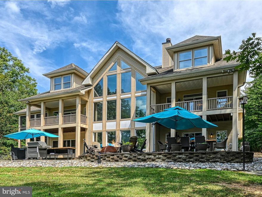 Welcome to your dream lakeside sanctuary! Nestled in Bluewater's gated community on the public side of Lake Anna centrally located with deep water, this luxury waterfront home offers an unparalleled retreat experience with its unique blend of rustic charm and modern luxury. Fully furnished three levels, boasting 6 spacious bedrooms and 5.5 bathrooms, including 4 luxurious primary suites designed for ultimate comfort and privacy. All bedrooms feature brand new bedroom sets and Beautyrest mattresses, main floor primary bedroom has blackout ceiling to floor curtains and private waterside balcony. Immerse yourself in the high end lodge cabin aesthetic with a grand stone wood-burning fireplace, dining at the custom cut live edge maple slab 10' table, antler chandeliers, sconces and other fixtures that were special imported from Manitoba, Canada, 100-year-old pantry barnwood doors and the warmth of the well-appointed interiors. Experience the best of both worlds with 2 levels of wall covered tinted windows, providing abundant natural light while minimizing glare and heat with waterfront views from almost every room in the home! Drink your morning coffee with a waterside view from the oversized screened in porch with outdoor flatscreen off the kitchen. Indulge and entertain in the finished basement fully equipped with a 92inch Movie Theatre with sound bar, poker table, pool table, and game room—perfect for fun-filled gatherings. The state-of-the-art Sonos sound system enhances the ambiance throughout. Home is complete with AEGIS security system, multiple brand new flatscreens throughout, private work from home study/office with custom cut live edge waterfall 6' desk table. Enormous lake level patio features premium Offenbacher outdoor furniture, Traegar smoker, BBQ grill, fire pit, fireside Adirondack chairs, freshly stained outdoor dining table and matching counter-bar with oversized outdoor umbrellas for cool shade. Take the golf cart path (golf cart included) to an immaculate 3-slip 75 ft boathouse where the fun never ends, featuring a tiki bar kitchenette including like new fridge and wine and beverage center, a 2nd Sonos sound system so you never lose the beat, kayaks, canoes, paddle boards and more! Make memories sitting at the dock around the fire, enjoying lake sunsets, expansive open water views, and sunning on the oversized sun deck. 2021 23’ Berkshire Tritoon, 2020 26’ Regal Boat, two 2017 Sea-doo Jet Skis, boat trailer and jet ski trailer available for purchase separately.  This is a rare gem, offering unique luxury and an exceptional lifestyle. Don’t miss the opportunity to make this captivating retreat your own! iGuide Home Tour available under virtual tours link.