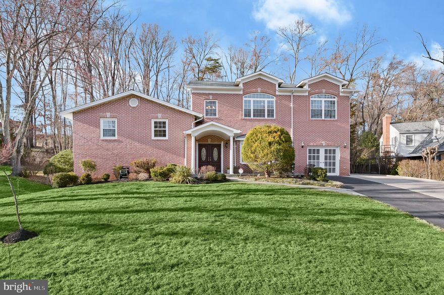 Great new price on this perfectly appointed home on over half an acre in the Lake Normandy Estates neighborhood, with ideal layout & space for multi-generational living!  11514 Karen Drive is exquisitely expanded and beautifully upgraded, offering 6 Bedrooms and 4.5 Bathrooms throughout. The residence showcases impeccable finishes to include gleaming hardwood floors, tray ceilings, marble wainscoting, beautiful built-ins, and recessed lighting throughout numerous living and gracious entertaining spaces. The property was meticulously and significantly expanded in 2008 to add the Main Level’s Family Room and another bedroom level. Since then, the home has been continuously upgraded throughout the years to include a 2020 remodeling of the kitchen, 2014 remodeling of all bathrooms, replacement of all windows in 2018, new roofing in 2016 and much more. 
A lovely covered front porch with double entry doors opens to the breathtaking 2 story marble foyer, creating an eye-catching and grand welcome to the home’s vast interiors. Featuring 9’ ceilings and glistening hardwood flooring throughout, the Main Level’s open floor plan is thoughtfully curated for effortless living. From the Foyer, an arched entryway leads to the Formal Sitting Room that opens to both the Dining Room and Family Room, creating a seamless flow for entertaining. Added in 2008 during the home’s significant expansion, the inviting Family Room features a Gas Fireplace and French doors onto the newly finished rear Deck (2022), offering an idyllic setting for al fresco dining and entertaining. Impeccably remodeled in 2020, the Gourmet Kitchen is perfect for every caliber of chef and features quartz counters, custom cabinetry, large center island, high-end stainless-steel appliances, and a cozy breakfast area with bay window. An attached Garage is accessible through the Main Level and rounds out the amenities the floor offers. 
The Guest Quarters are located on the first Upper Level and are complete with hardwood flooring throughout. 2 of these Bedrooms, also perfect for office space, share the Full Hall Bath, outfitted with porcelain tile floor, modern vanity and tub/shower. The 3rd Bedroom on this level features an en-suite bathroom with an oversized stall shower and marble surround, bench seat and porcelain tile floors. 
Added during the home’s 2008 expansion, the second Upper Level, is comprised of 2 secondary Bedrooms showcasing large windows with arched transoms, which share a Full Hall Bathroom with marble wainscoting and granite vanity countertops. An expansive Primary Suite features double entry doors leading to the Suite’s entry hall replete with 2 Walk-In Closets. The Primary Bedroom features elegant design details to include tray ceilings, recessed lighting, and a serene sitting area. The spa-like Primary Bathroom is an oasis complete with marble flooring, a jetted soaking tub with marble surround, dual vanities with granite counters, a skylight, marble stall shower and separate water closet. 
The walkout Lower Level features a Laundry Room with access to the side yard, a Powder Room, and an expansive Recreation Room complete with a wall of built-ins, a Wood-Burning Fireplace with brick surround and a sliding glass door to the tranquil screened Porch. An additional, unfinished Lower Level located below this floor provides utility and storage space in abundance.