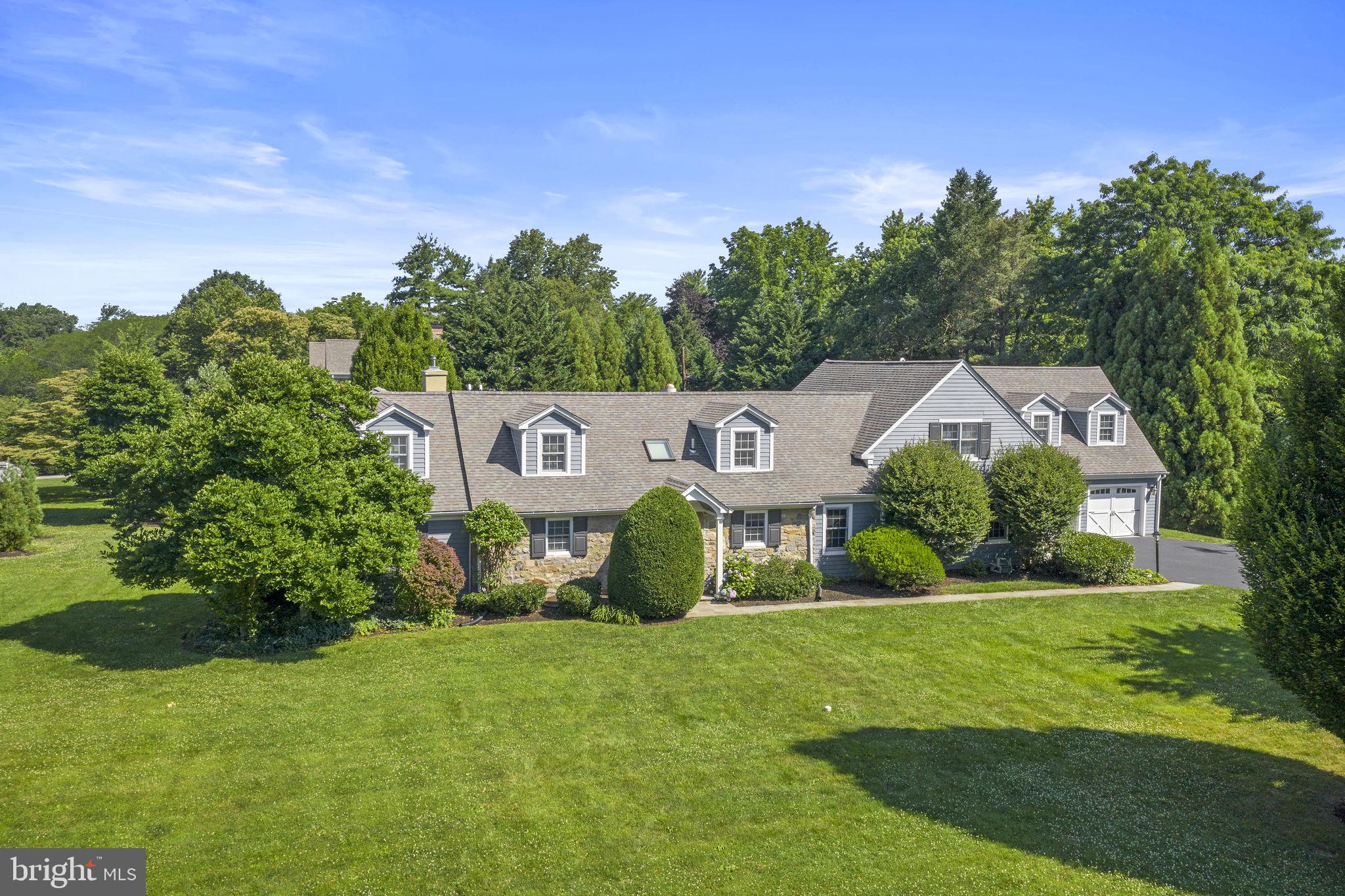 Refined interiors and park-like grounds create a luxurious and versatile 6 Bedroom 6.5 Bath home in Lower Merion Township. Inside the 6,000 square-foot residence the vaulted entry way introduces the gracious and sophisticated living and entertaining spaces highlighting the extensive renovations and additions that include hardwood floors and millwork throughout with tremendous attention to detail. Upon entering the foyer, the large formal dining room has a painted accent wall with windows that showcase the 550-bottle temperature-controlled wine room. The formal living room has a large bay window, gas fireplace with detailed woodwork and access to a private “hidden” office that has built-ins and beautiful windows. The stunning kitchen is a gourmand’s delight with crafted cabinets including multiple china cabinets and built-in command center, granite topped buffet, breakfast bar that seats 4+, granite tops, center island with butler’s sink, and top of the line appliances including a six-burner GE Monogram range, double ovens and a vented range hood, Sub-Zero refrigerator, an LG dishwasher, two sinks, radiant heated floors, and a Kenmore Convection microwave. An adjacent sun-filled morning room welcomes casual dining. There is a separate butler’s pantry that is equipped with a KitchenAid ice maker, second LG refrigerator, KitchenAid oven, and Bosch dishwasher and provides access to the wine room. The two-story family room houses a wall of windows that overlook the beautiful, private back yard. French doors lead to large slate patio, with retractable awning, that extends to an outdoor fireplace and wood burning pizza oven housed under a wisteria-covered pergola. The back of the home meets the needs of everyday living and is a true haven for entertaining! Adjacent to the breakfast area is a second office/den, mudroom, half bath, back stairs and access to the two-car heated garage that has been expanded to include additional storage with separate access doors to the back yard. The private first-floor bedroom suite is wheelchair accessible and includes a custom bathroom and closets allowing for a variety of uses.
The second floor includes 5 additional bedrooms and 4 full baths. The primary bedroom features separate closets, large bath with jacuzzi tub, radiant heated floors, large shower with seamless glass door and double vanities. In addition to this bedroom there is a guest suite with private bath, two bedrooms adjoined by a jack-and-jill bath, and another bedroom suite with private bath and generous closets that is accessed from the back stairs. There is a large laundry room with shelving and storage and generous linen closets throughout. The finished Lower level is ideal for many uses with rec room, separate offices, and full bath. There is also unfinished storage space and the mechanicals.
The attention to detail and care is evident throughout the home creating unique settings for entertaining as well as the living spaces any family desires. With Two separate Offices the ability to work from home could not be more convenient & allows for the flexibility needed in the current work/professional environment. The location is close to shopping, the airport, regional rail and schools. Numerous parks are close by - Ashbridge Park that has over 28 acres dedicated to playgrounds, running trails as well as tennis and sledding. Stoneleigh is up the street and features 42 acres available for exercise, picnics, and horticulture. The combination of the private setting of the home with the accessibility of these amenities creates a perfect balance for today's family.