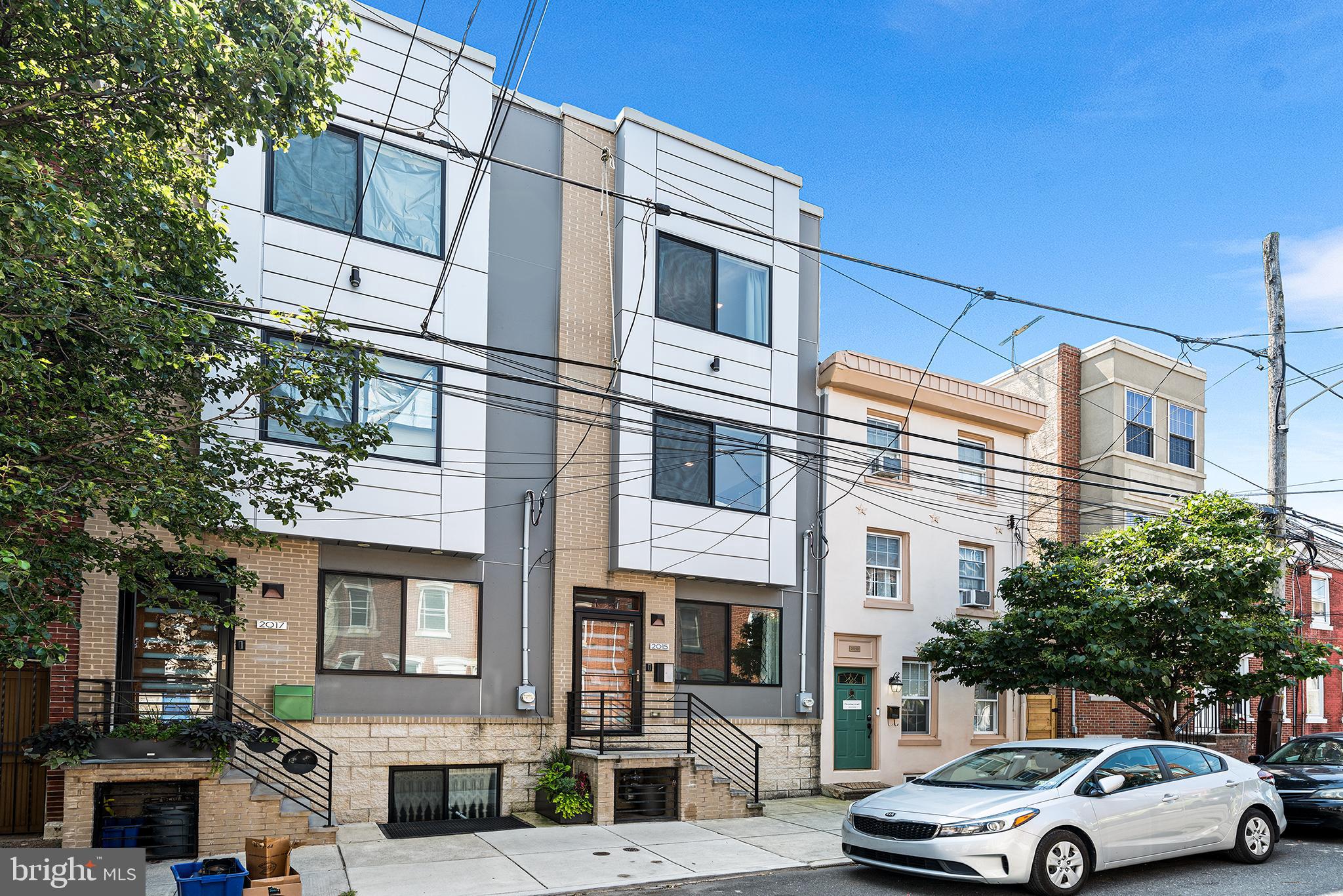 Move in ready in the heart of Fishtown! 2015 Tulip is a stunning home located steps from Frankford Ave and Konrad Square Park on a quiet residential block in the heart of Philly’s trendiest neighborhood. Completed in 2019, this spacious 3 bedroom, 3 bathroom home also features a finished basement and private roof deck. No detail has been overlooked in this modern, impeccably maintained property. Upon entering, you’re greeted with a modern wood front door, large windows, soaring ceilings, a fresh paint job and a flexible living/dining layout. The sunny kitchen has plenty of storage and prep space, a farmhouse sink and a stylish glass tile backsplash. The kitchen has clear sight lines to the living room and offers easy access to the cheery patio through a glass panel door. Room for gardening and grilling right off the kitchen! Continue upstairs to explore 2 spacious bedrooms flooded with natural light through the oversized windows and each with large closets. This floor also includes a generous full bathroom with designer tile, a bathtub and a large vanity. The sun drenched primary suite is located on the third floor which also features a bathroom with double sinks and a massive glass enclosed shower as well as a separate laundry closet with storage and a stacked, full-size washer and dryer. Ascend to the fourth floor to access a lovely roof deck boasting skyline and treetop views. The full footprint finished basement adds incredibly usable square footage and has another full bathroom, tall ceilings, good light and offers even more space for hobbies, fitness, work from home, movie nights etc. Pride of ownership is apparent in every aspect of this beautiful home and you’ll enjoy 4 more years of lower property taxes with the tax abatement (abatement ends 6/30/29). Enjoy the walkability and bike-ability of Fishtown and a convenient commute to center city via public transit. Or stay closer to home with Riverwards Produce, Tulip Pasta & Wine Bar, Amy’s Pastelillos and Reanimator Coffee all right around the corner. Don’t miss your opportunity to live in the heart of it all!