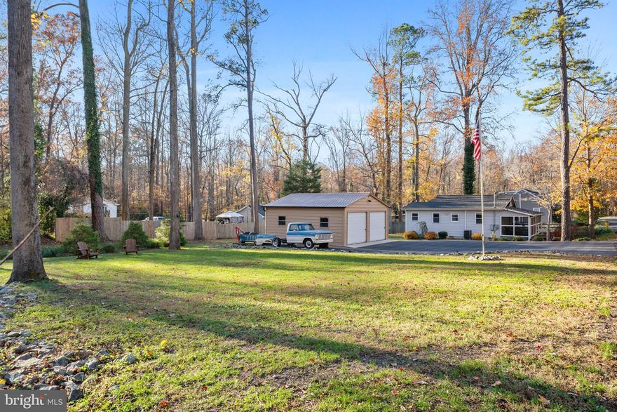 Charming Rambler in St. Leonard (w/ .40 Acres)

Tucked beneath a canopy of mature trees, this charming St. Leonard rambler feels like a retreat you’ll never want to leave. From the moment you pull into the drive, the home invites you in with its welcoming screened-in front porch—the spot for slow summer mornings with coffee, breezy afternoons in the hammock swing, and cozy fall evenings listening to the crackle of leaves.

Step inside and you’ll find a home filled with warmth and character. The living area is centered around a wood stove that brings the whole space together, perfect for chilly winter nights or creating that classic Southern Maryland cottage feel. Natural light filters in through the windows, tying together the soft tones, hardwood floors, and comfortable layout.

The galley-style kitchen is both charming and functional, featuring white cabinetry, butcher-block counters, and ample storage throughout. A picture-perfect window gives you a front-row seat to the peaceful wooded backyard while you cook, wash dishes, or simply take in the quiet.

Down the hall, you’ll find three well-sized bedrooms with great closet space and plenty of natural light. The primary bedroom is surprisingly spacious and includes its own ensuite bath for added convenience. The second bathroom is beautifully updated with modern tilework and a glass shower.

Outside, the .40-acre lot offers the best of both worlds—manageable and easy to maintain, yet private and surrounded by nature. There’s plenty of open yard for play, gardening, pets, or simply setting up chairs under the tall trees to enjoy the serenity. A large detached two-car garage provides excellent storage for vehicles, tools, hobbies, or weekend projects.

Whether you’re looking for a peaceful full-time residence or a comforting getaway, this rambler captures the spirit of Southern Maryland living—simple, relaxing, and full of charm. This charmer won't last long - schedule your private tour today!