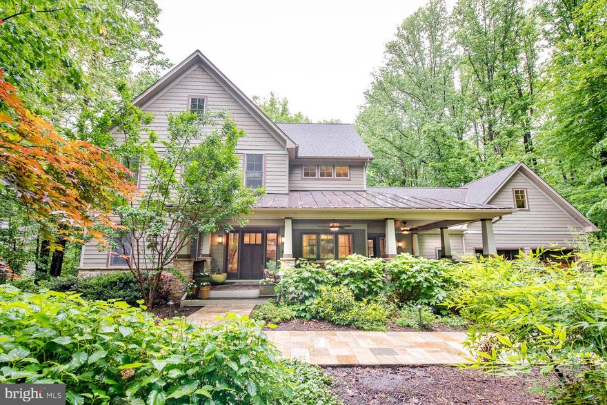 This custom Craftsman home was inspired by architect Sarah Susankah’s design philosophy “build better - not bigger”.  Built by Kohlmark Homes and interiors designed by Shannon Munn of Ambi Design Studio. Every material, finish, and room design was crafted with the goal of creating a timeless, welcoming home. Centrally located < 5 min to Route 66 &  FFX County Parkway, but worlds away from the bustle of Fairfax. Be transported to the beauty and calm of the woods with 1+ ac lot backing to 20+ ac of woods, streams & miles of walking paths and designed to be a part of its woodland environment with extensive use of natural stone, hardwoods, and landscaping. While boasting nearly 6,000 fin sq ft, it doesn’t shout its size but rather nestles into the landscape.

With 1,000+ sq ft of outdoor living space you’re welcomed home to the sound of a bubbling pond and  expansive covered front porch with mahogany floors and rails, stone columns capped with a standing metal roof invites you to relax and enjoy the prof designed and mature front yard and well suited to hosting large gatherings or birdwatching from the porch swing. There’s also a screened porch and large back deck and balcony off the primary br, and a huge deck with cedar planters and privacy wall off the basement apt.

Welcome to comfort and ease of lifestyle crafted to delight the senses. Each material was selected with quality and permanence in mind like the warmth of the solid brass door knobs and the weight of the solid oak doors.  Enjoy quiet, calm & efficiency of 6” walls, Anderson windows and doors. Delight in custom woodworking throughout and feel the richness of the Lyptus hardwoods and Karastan wool carpets under your feet. Gaze out every window onto the glowing green of the woods.

Woodland Oasis is designed to adapt to your changing needs with versatile layout and spaces that can transition as your life evolves. The kitchen includes a butler’s pantry or children’s study nook. Adjacent to the great room, you'll find flexible space suitable for a music room, 2nd office, or main floor br with minor adjustments. The home library doubles as another office space. The mudroom offers convenience with a raised shower for dog grooming or post-outdoor clean-ups. Upstairs, a spacious bedroom can serve as a guest suite or be converted into a luxurious primary bath. The finished room over garage can function as a gym or a lavish owner’s closet. The basement, currently rented as a separate apartment, surprises with a movie theater equipped with a kitchenette, built-in screen, and projector wiring. The basement ceilings feature top-tier sound dampening. 

Some features include a mature landscape designed for minimal watering and care, anexterior built with color embedded Hardie Plank siding and Azek trim boards - limiting exterior maintenance. LED lighting throughout and all lights on dimmers controlled by a home automation system; storage of every shape and size, custom designed closets, storage shed for your lawn needs, 2 large basement storage rooms. The kitchen, dining room, and butler’s pantry boasts extensive solid wood cabinetry - capable of holding all your dining and entertaining paraphernalia; the mudroom storage includes cabinetry and a closet for your cleaning supplies, and the over-sized garage has both a work space and additional storage. 

Beauty, flexibility, and practicality make this home special. Quality construction and finishes, thoughtful design don’t fully capture the essence of this home. The owners have spent the last 20 years designing, building, and improving this home, raised their children, hosted family and friends, and dreamed this would be their forever home. They’ve poured their love, imagination, time, blood, sweat, tears, and treasure into their home and desire the next family will love, grow, and find comfort in the welcoming embrace of Woodland Oasis - as they have.