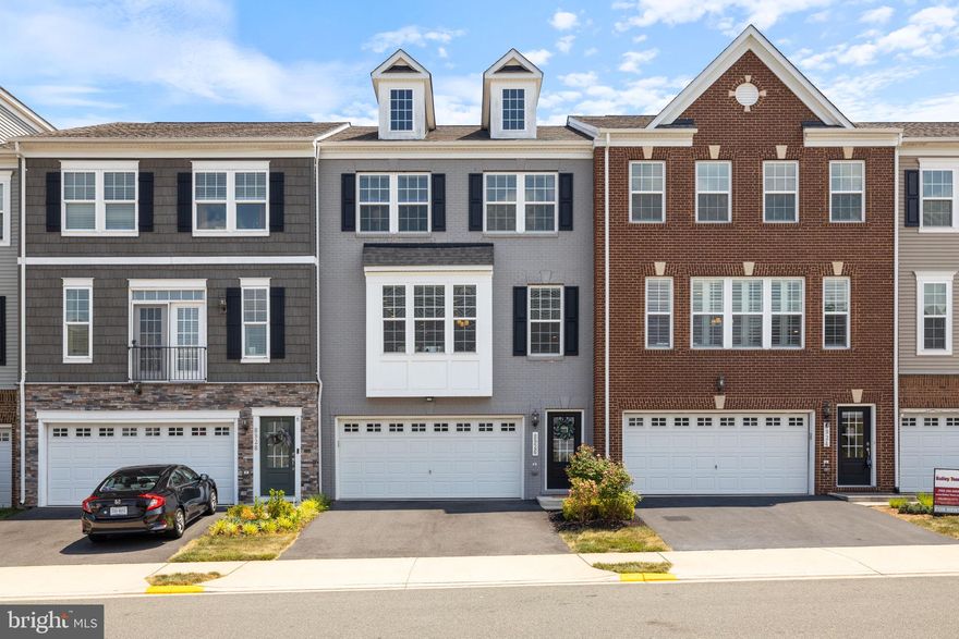 Built by Stanley Martin in 2018, this freshly painted, bright, and airy luxury town home with an oversized two car garage has everything you could possibly need.  In the heart of sought after Bradley Square, this home  boasts an open concept and gourmet kitchen with an expansive island, quartz countertops, 42 inch cabinets with crown molding, and all stainless steel appliances including a new LG refrigerator (2023).  The box bay window off of the dining room provides additional sunlight and square footage, making this one of the largest models in the neighborhood.  Enjoy high ceilings throughout and a fabulous deck off of the living room! The seller is also offering a credit of $2,000 towards the replacement of the deck boards. Upstairs, there are three bedrooms including an enormous primary bedroom suite with an en-suite attached luxury spa bath.  The lower level rec room is perfect for entertaining, and there is a lower level full bath too! The front yard and fully fenced-in backyard are landscaped perfectly.  In addition to an upper deck, the lower level patio offers additional outdoor "hang out" space.  Multiple playgrounds and a community splash pad are right by the house.  This location is also just a hop, skip, and a jump to Old Town Manassas, The Fairgrounds, and Community Square.