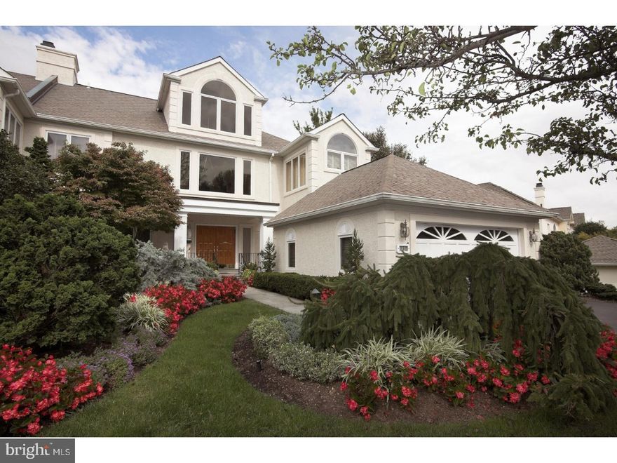 What a beauty! charming yet contemporary, this exquisitely designed, pristinely maintained stucco carriage-style home, built in 1993, has undergone thoughtful upgrades to its original floorplan as well as the inclusion of high-end finishes & amenities. You'll love going home as you pull into the oversized 2-car garage, then proceed down the inviting paver stone walkway leading to handsome double wood front entry doors. A fabulous soaring reception area with sweeping staircase, gleaming wood floors, tiers of massive windows & wide openings to the main rooms impresses you upon arrival inside. The light-bathed 5,358 sf house boasts generous formal & informal living spaces spread over 4 gracious stories. An elevator, designer lighting, elegant moldings, gorgeous frosted glass doors & other modern elements create what feels like a work of art.  Host gatherings in the expansive living room with arched windows & open family room that extends to the outside space beyond sliding glass doors. A dining room graced by hardwood floors with a sleek marble tile inset & decorative border provides a perfect setting for serving a crowd. Connected is the chef's kitchen, equally noteworthy with a big center island with seating & black granite countertops. Extensive cabinetry & pantry storage and stainless steel appliances round out the cook's paradise. A sunny breakfast area extends to the outdoor patio through glass doors for morning coffee breaks. The main level also presents a laundry room & stunning half bath. Up the artful staircase or elevator awaits a light-bathed upper landing and spacious master suite with an adjacent office/sitting room, filled with natural light. The stylish master bath features a freestanding oval sink vanity in center, windowed soaking tub niche & sizable spa shower. A huge outfitted walk-in dressing room/closet for him & her provides ample storage. Additional bedrooms & full baths, a den & bonus spaces on the 2nd & 3rd  floors provide versatility. The finished day-lit walkout lower level is a haven for casual entertaining & hanging out family, with an amazing rec room with fireplace, built-ins, full bar, bedroom & full bath. This home is a one-of-a-kind home.