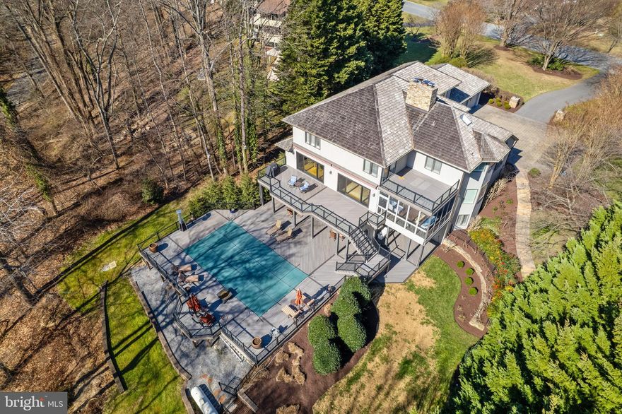 Exquisite Contemporary Colonial home in the highly coveted Downs on the Severn community! This stunning residence is situated on a premium 1 acre lot with captivating water views of Clements Creek and the community marina, offering a truly idyllic setting. Inside, the home boasts impeccable attention to detail, highlighted by gleaming wood floors, cozy fireplaces, stacked stone accents and walls of windows framing the water and nature views. The thoughtful floor plan provides the best of both worlds with the formal areas; home office, dining room and living room transitioning into an open floor plan showcasing the family room, gourmet kitchen and breakfast nook . The perfect layout for gatherings large or small. Spacious, light-filled kitchen with large island and high-end appliances will please even the most seasoned chef.  Enjoy the cool summer breezes from the screened porch or relax year round on the expansive decks on all three levels, providing ample space for outdoor enjoyment by family and guests. Step into your private oasis as the backyard beckons with a refreshing heated pool, expansive pool deck, and a beautiful view; perfect for lounging. Create lifelong memories in the comfort of your own outdoor haven. Ascend the stairs to discover generously sized bedrooms, including the luxurious primary suite with water views, fireplace, private balcony and a generously sized spa-like bathroom with natural light pouring in from the skylight. The fully finished lower level adds another layer of luxury, offering an additional 1,800+ sqft of living space.  The party ready wet bar with plentiful seating, sliding doors opening out to the pool deck, full bath, exercise room, cozy fireplace and tons of storage is the epitome of indulgence. Completing this magnificent property is lush mature landscaping, a 3-car garage with motor court, close proximity to the marina for the boating enthusiast and the joy of being part of a wonderful community filled with amenities. Embrace the ultimate in waterfront living with access to a clubhouse, tennis/pickleball courts, a community pool and 2 deep water marinas,  – all part of the desirable amenities within this water-privileged community. Seize the opportunity to make this exceptional residence your home. Welcome Home!