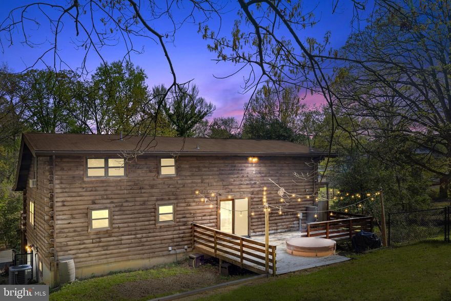 Escape to your own private log cabin retreat – just minutes from DC.  Are you looking for a home that feels like you're living in the middle of the woods but are only one exit outside of DC?  This log cabin is a unique blend of seclusion and accessibility all in one! This stunning 4-bedroom, 2-full bathroom log cabin sits on a sprawling 0.93-acre lot, offering 3,113 sq. ft. of rustic charm with modern convenience. Nestled on a dead end road, this home is ideal for those who crave space and privacy without sacrificing urban convenience.
Step inside to discover warm wood interiors, vaulted ceilings with exposed wood beams and a cozy pellet fireplace, creating an inviting atmosphere perfect for relaxation. The spacious primary suite, along with three additional bedrooms, ensures plenty of room for family or guests. The spacious kitchen with stainless steel cabinets offers rustic cabin charm and plenty of counter space.  Out the glass doors in the rear of the home you will find an open deck with views of the beautifully wooded yard and blooming trees.  The side yard offers a fenced in dog run and access to the side of the wrap around porch.  The expansive wooded lot offers endless possibilities—whether you dream of a serene garden, outdoor entertaining, or subdividing the lot and building another property!
 The lower level offers the fourth bedroom with adjoining bathroom, a separate living space or rec room with high ceilings, and a  kitchenette - great for a separate guest space, a separate income producing rental space, or a large exercise room.   An additional side entrance from the basement level offers easy access from the driveway. 
Multiple options of public transportation with a bus stop on the intersecting street and just 1.5 miles to the Landover Metro station and 2.4 miles to the Cheverly Metro station on the Orange Line.  Down the street from shopping, restaurants and access to the Baltimore Washington Parkway.
