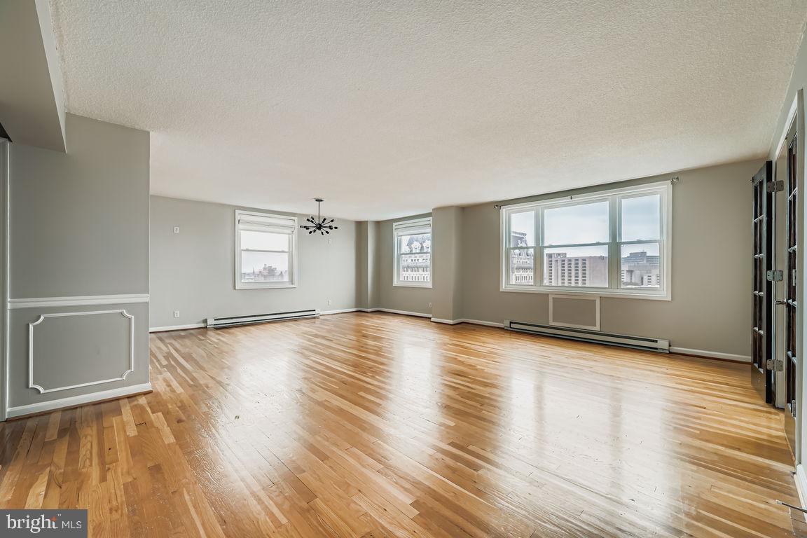 Beautifully renovated, fresh fixtures and finishes, upper level corner unit in full-service, secure, elevator building with 24-hour front desk and on-site management. Polished gleaming hardwood floors throughout. NO CARPET. Laundry in unit. Gorgeous panoramic views from three sides. From the city skyline and Washington Monument, to Penn Station - see it all. Filled with impressive historic architecture, lively Mount Vernon location offers dining, shopping and city convenience. Live in the Arts and Cultural hub just a few blocks from Penn Station with trains to NY, DC and other East Coast locations. Enjoy the Walters Art Gallery, the Meyerhoff Symphony Hall, and the Lyric Opera House. Convenient to downtown, UB, MICA and Peabody Institute. Parking in attached underground garage available for monthly fee. All utilities, except electric, included.