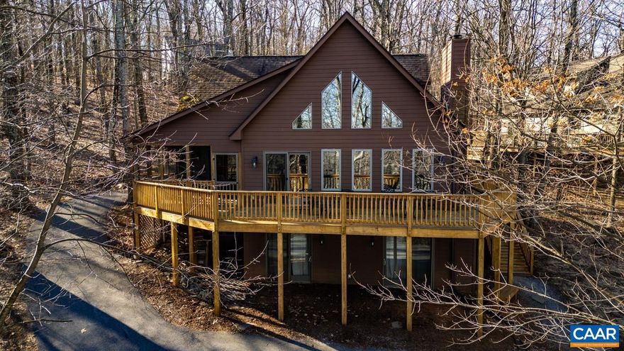 A very attractive house in the middle of Devils Knob Golf Course.  Two living areas.  A full kitchen on lower level with access to parking.  Main level has a full second kitchen, master bedroom & guest bedroom, porch & deck.  Top level has additional bedrooms & loft area.  Home has been a strong rental within the Wintergreen Rental Program.  Rental income figures are available through your agent or listing agent.,Birch Cabinets,Formica Counter,Fireplace in Living Room