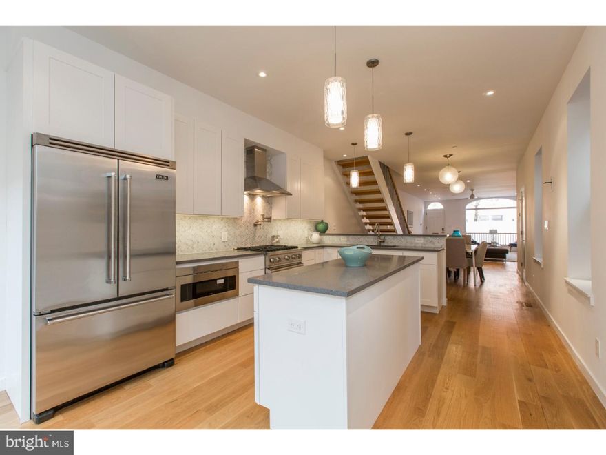 Stunning home in the most luxurious neighborhood in Philadelphia, Rittenhouse Square! This unique property has been rehabbed from head to toe with the highest quality materials such as white oak, quartz counters, luxury appliances and high-end fixtures offering a perfect mixture of modern details and classic charm. Enter and discover the open layout living room featuring a breathtaking Marble Fireplace, high ceilings and recessed lighting. Continue through the spacious dining area to the state of the art chef's kitchen equipped with a breakfast bar, island, Viking stove with XO Exhaust, refrigerator, a microwave style drawer, Quartz countertops and a Carrara marble back-splash. Through the sliding glass doors, you will find the back yard, perfect for outdoor entertaining and relaxation. Upstairs you will find four light filled bedrooms, two on the second floor and two on the third floor. Both front bedrooms feature Master Suites with en-suite bathrooms featuring marble flooring and dual vanities. Each bedroom comes equipped with closet space, the 2nd floor Master possesses a "his and hers" closet while the 3rd floor Master has a walk-in closet with custom shelving. Finally ascend to the top deck with unbeatable 360 views of the city, framed with glass railings and is water, gas, and electric ready! Last but not least is the finished basement with tile flooring, a Media Room with a built-in surround sound system, a spacious 8' x 8' Wine Cellar & a sizeable finished Storage & Utility Room. In addition to all of this you will also enjoy multi-zoned Lennox HVAC system, a "Control 4" Central Smart Home System and the wiring to customize network, security systems and a detached 2 car garage. At this location, you will be at the most desirable location in town! Walk to top restaurants, shopping parks and entertainment. Don't wait schedule your showing today!