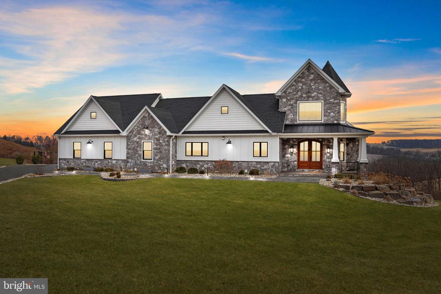 Welcome to 176 Fenstermacher Road, an exceptional custom-built estate by European Builders, perfectly situated on 3 private acres with stunning hillside views in Kutztown. This home seamlessly blends refined craftsmanship, advanced technology, and resort-style living. The heart of the home is a chef’s kitchen featuring GE Café appliances, custom Woodmont cabinetry, a hidden walk-in pantry, and generous prep space, all filled with natural light from Pella windows and enhanced by vaulted ceilings. The residence offers six bedrooms, all with custom closet systems, along with three full and two half bathrooms, and dual-zone heating and cooling for year-round comfort. The three-car garage connects directly to a private home gym, while the lower level delivers a spa-like experience with a steam room and sauna. Additional highlights include a whole-house sound system, smart blinds, EV charging hookup, two Elkay bottle fillers, a Generac whole-house generator, and a thoughtfully designed mudroom with a dog shower and dog bowl water-filling station. Step outside to your own private resort featuring a saltwater pool and spa, water feature, custom fire pit, half-court basketball and tennis court, and a custom Amish-built playground, all set against peaceful countryside views. A 1,000-gallon propane tank provides efficiency and reliability. A rare opportunity to own a meticulously designed luxury home offering privacy, recreation, and elevated living in one of Kutztown’s most scenic settings.