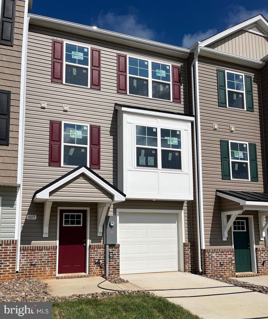 New Town Homes under construction in The Communities of Burwell featuring 1875 sqft of living space. Home has bump outs in main level family room, spacious open floor plan, 4 bedrooms/ 3.5 baths, Kitchen with granite countertops, separate island and island bar to family room, stainless steel appliances, and luxury vinyl plank flooring throughout the main level. The upper level primary bedroom has vaulted ceilings, walk in closet, and full bath with tile shower and glass door. The lower level offers 4th bedroom and full bath. Exterior brick on front, 1-car garage with auto opener, and concrete driveway included. **interior photos are similar construction**