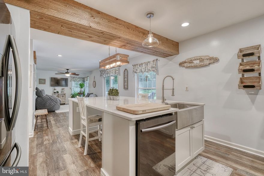 **SELLERS ARE MOTIVATED!!** Welcome to 399 E. Wheel Rd! Be Prepared to Fall COMPLETELY IN LOVE with this BEAUTIFULLY Updated Colonial, located in Bel Air on a Private and Secluded 1/2 acre lot!  With a Warm and Sophisticated Farm-House-Chic Flare throughout, even Joanna Gaines would be Inspired!! As you pull up to the home, you'll find plenty of Space for Parking on the Newly Paved Driveway, as well as a 12X18 shed!  Walking towards the home, you'll find an adorable front porch that is awaiting your Rocking Chairs! Stepping into the home, you'll find a Beautiful Dining Area to your right and a Spacious Living Room to your left. Off of the Dining Room is an Absolutely  Stunning Remodeled Kitchen--Straight out of HGTV Magazine!! Complete with Farmhouse Sink, Black SS Appliances, a HUGE Island perfect for entertaining and lots of guests, Beautiful White Cabinetry, a Hooded Range, Pantry and more! Up on the Top Level of the home you will find 2 generously sized Bedrooms, a Full Hall Bath, and an Owners Suite with a HUGE walk-in closet that can be converted back into a 4th bedroom if desired! In the Owners Suite is a GORGEOUS totally remodeled Bathroom, featuring a Double Vanity with lighted mirrors, Soaking Tub, Private Toilet, and Separate Shower! Another Bathroom Straight out of HGTV Magazine! Downstairs in the Lower Level of the Home is another Full Bath, Large Recreational Area, Separate Laundry Room, Bonus Den that could potentially be a Bedroom, and a large storage room! Outside in the Privately Fenced Yard you will love the sounds of nature and of course the privacy it brings! Enjoy entertaining on the back and outdoor living space! This one is a true 10/10! Dont Miss Out! Schedule Today! UPDATES INCLUDE: TRANE HVAC 2018, FENCE, PRIVACY TREES PLANTED IN FRONT, KITCHEN 2019, PRIMARY BATH 2020, DRIVEWAY 2020, FLOORING & CARPET 2018, WHOLE HOUSE HUMIDIFIER AND SECURITY SYSTEM.