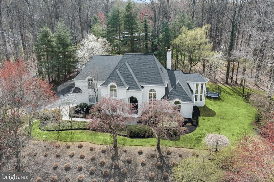 Situated on over two acres in the Premier Anton North neighborhood, this custom home has been meticulously curated with no detail left unturned. The flawless interior design features a clean and timeless aesthetic completed by modern archways, beadboard walls, custom lighting and endless unique architectural features. As you enter through the grand foyer, you are greeted by three-story ceilings, custom moldings, white oak engineered hardwood flooring and designer lighting. Make your way to the living room adorned by a gas fireplace with custom tile surround, built-in bar and opening to the stunning dining room, you will immediately notice the abundance of natural light that accentuates the open floor plan, making it perfect for entertaining. The updated, gourmet kitchen with new stainless steel appliances, featuring an Ilve 40" lacquered brass/stainless steel range with side by side oven, Italian tile floors and backsplash, marble countertops and high end lighting and hardware, make this a chef's dream. Entertaining is seamless as the kitchen flows right into the handsome family room, with an Italian herringbone tiled fireplace, shiplap wall detail and crown molding. Step out from the sliding doors in any room to your private outdoor oasis, a true blend of indoor/outdoor living and an entertainer's dream. The oversized deck with separate dining and seating areas steps down to an outdoor kitchen, completed by a refrigerator, grill and Big Green Egg. With the waterfall feature, small pond, gazebo, patio chess set and trampoline, this will be the home everyone will want to come back to. Back inside, you will find your own sanctuary in the two-story primary suite completed by an electric fireplace, two walk-in custom closets, a spa bathroom, recently updated with an oversized jacuzzi tub, dual vanities and remodeled shower and a spiral staircase leading to your own private loft, perfect for an office.  Finishing off the main level is an in-law suite with a spacious bedroom and remodeled bathroom. Upstairs you will find five additional bedrooms (one of which has been converted to a full gym), three full bathrooms, a spacious second floor loft which leads upstairs to a third floor hangout with a pool table that conveys. Make your way to the fully finished lower level featuring a wet bar that is centrally located between the game room and living room. The fully-finished lower level offers a spacious recreation room with a custom wet bar and accent wall, along with a versatile bonus room and a full bathroom. The circular driveway, three car garage and breathtaking landscape put a finishing touch on this absolute masterpiece home and with its premier location and proximity to the beltway, restaurants and shops, this home is truly one of a kind.