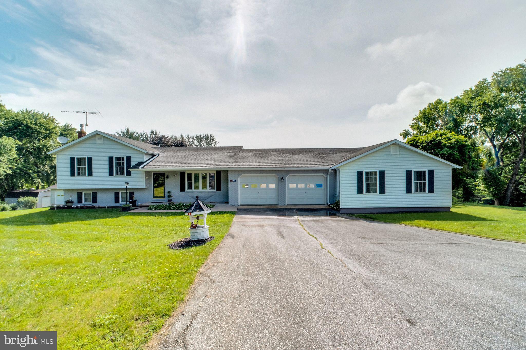 Welcome to 1423 Hallowell Ln!! A truly special 4-bedroom, 3.5-bath home set on over 1.5+ acres of private, beautifully landscaped land, offering over 2,800 sqft of finished living space and multiple areas designed for both everyday comfort and effortless entertaining. From the moment you arrive, you’ll feel how well this home has been cared for, upgraded, and designed to live in. The main level features a bright, open layout with wide wood-plank porcelain tile flooring, fresh paint, and a fully renovated gourmet kitchen with white soft-close shaker cabinets, Calacatta Ultra quartz counters, stainless steel appliances, and a stunning 7-foot double-sided waterfall island, all framed by Andersen windows that flood the space with natural light. Step right out from the kitchen to an oversized composite deck with custom lighting, perfect for summer dinners, morning coffee, or relaxing under the stars. Host weekend BBQs on the paver patio, all overlooking a fully fenced backyard with mature trees and open sky views. A true outdoor retreat. There’s also a detached 2 car garage tucked privately near the back of the lot, ideal for hobbyists, extra vehicles, or workshop space, in addition to the attached 2 car garage. One of the standout features of this home is the fully independent in-law suite, complete with its own private entrance, full kitchen, and direct access to its own deck, which connects seamlessly to the shared patio and yard, perfect for multi-generational living, guests, or even rental potential. The lower level offers a finished rec room and an additional bonus level below that adds even more space for a gym, office, or storage. Recent updates include: HVAC, Andersen windows, water heater, water softener, well pump, fencing, decking, and more. Located in a peaceful setting with no HOA, but just minutes from Westminster, Mt. Airy, and key commuter routes, with easy access to shopping, dining, schools, and highways connecting to Frederick, Baltimore, and DC. If you’ve been waiting for the perfect balance of space, style, and flexibility, this is the one.