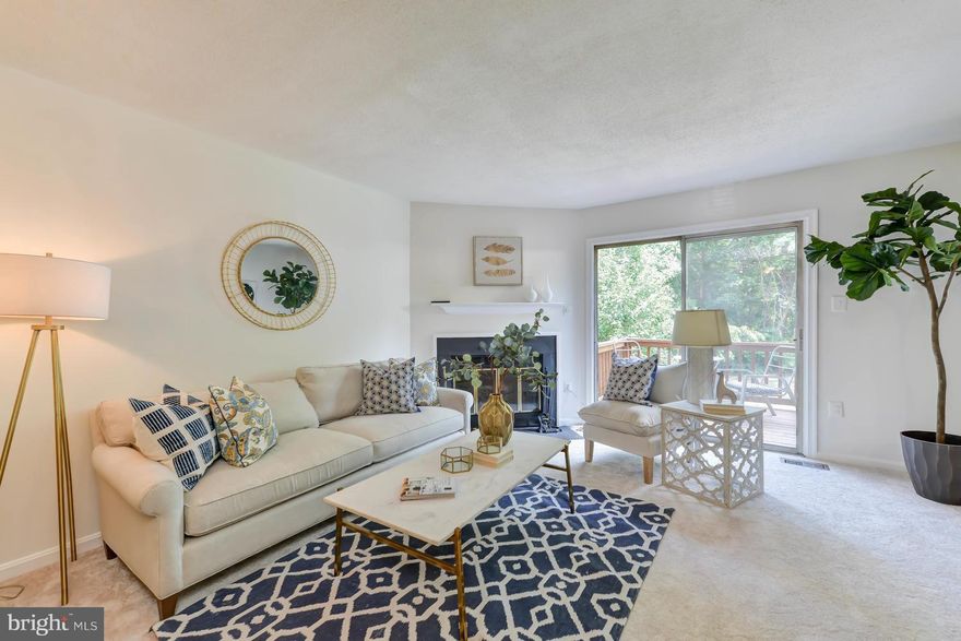 Great location close to Metro, shops, dining & interstate. Peaceful TH backs to trees & has a quaint "village-like" setting. Charming front porch+landscaping set the tone as you enter this 2 bed/1.5 bath home. New carpeting installed thru/out. Newer KIT apps & freshly painted cabinets. LR/DR combo w/lovely WBFP+walkout to deck. Spacious BR's & fully finished walkout LL w/rec room & laundry room.