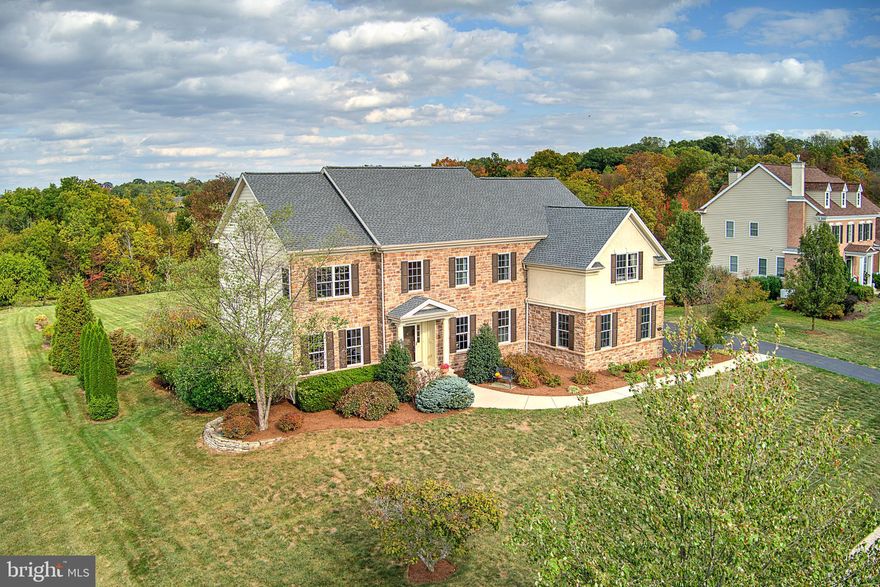 Welcome to 117 Telegraph Road in Perkasie, PA! This elegant residence features 4 bedrooms, 3.5 bathrooms, and boasts a spacious 4,300 above grade square feet of  living space on an expansive 1.72-acre lot. With plenty of open backyard space, there’s ample room to create your dream outdoor oasis.

Step into the dramatic two-story foyer and feel instantly at home with the open and airy floor plan. The main level offers an office with French doors and recessed lighting, a formal living room, and a dining room adorned with extensive moldings and more recessed lighting. The large kitchen is a chef's dream, complete with a pantry, island seating, and a sunlit morning breakfast room with walls of windows that flood the space with natural light. Hardwood floors flow seamlessly throughout this level, leading to an expansive living area with updated carpeting, a striking two-story stone fireplace, and a game closet with room for a hidden desk. The back hall leads to a convenient laundry room equipped with a sink, shelving, and ceramic tile with storage closets.

Ascend the back staircase to the second floor, where hardwood floors grace the steps and hallway. The primary suite is a sanctuary, featuring a sitting room, an upgraded bath with a large seamless shower, jetted tub, and double granite vanity. Three additional generously sized bedrooms, including a Jack and Jill and a Princess Suite with walk-in closets, complete this level.

This home also includes 9-foot ceilings on all floors, 8-foot doors, and a full 9-foot walk-out basement with rough-in plumbing for a future full bath, a sliding glass door leading to a large patio, and an abundance of windows. A three-car side entry garage completes this exceptional property.