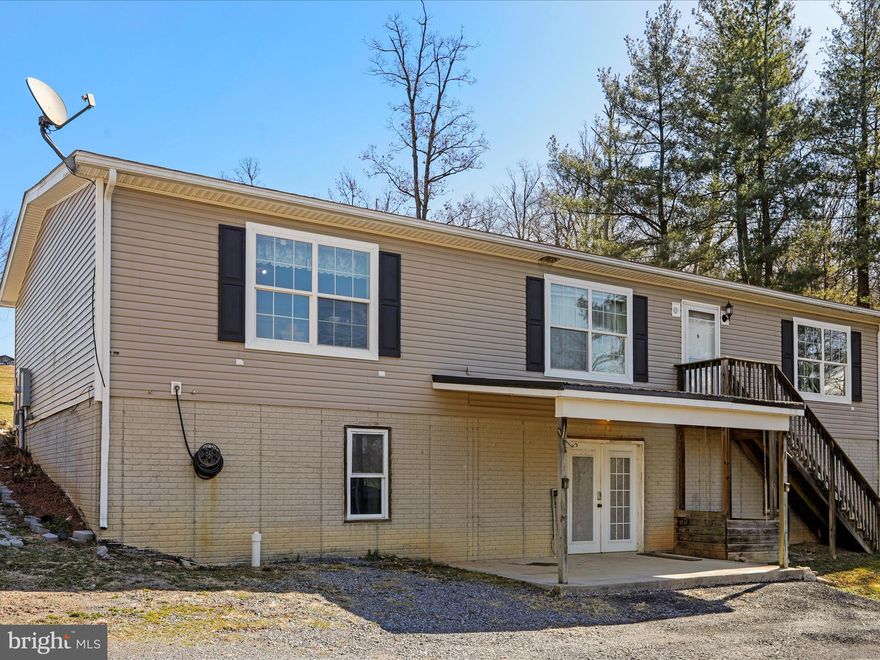 WHAT AN OPPORTUNITY! VERY MOTIVATED SELLER! 
Don’t miss your chance to own this spacious 5-bedroom, 2-bathroom home on a stunning 1-acre lot—now with a total of $74,000 off the original list price! This mountain retreat offers 3 bedrooms upstairs, including a large primary suite with a private en-suite bath, plus gorgeous new flooring throughout. New roof in 2023 with a transferable lifetime warranty!

Stay connected with high-speed fiber optic internet!

Relax on the wrap-around porch or get cozy by the wood-burning fireplace in the living room. The outdoor wood-burning stove provides efficient, year-round heating and also heats the hot water, ensuring an abundant supply for the entire home!

The walk-out basement includes 2 additional bedrooms and is roughed-in for an extra bathroom, giving you endless possibilities for expansion.

Enjoy peaceful mountain living with all the modern comforts—schedule your showing today before it’s gone!