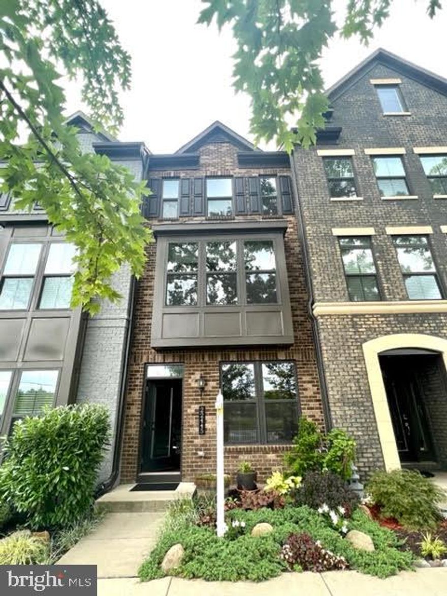 4 level Townhouse in the Westmoore Community right near the Ashburn Metro! This 3 bedroom, 3 full and 2 half bath townhouse has an open recreation room and half bath upon entering the first floor.  The engineered hardwood on every level, metal ballusters and oak stairs set the tone for the beauty of this townhouse.  The main level has a modern center kitchen with island, granite counters, backsplash, white cabinets, and stainless steel appliances. The great room has a bay window extension on one side of the kitchen, and the other side has a dining room.  Relax on your outdoor extended balcony.  The third floor has 2 bedrooms – the primary and secondary bath have quartz counters and upgraded floor/shower tiles.  The top, fourth floor has a loft with bedroom and full bath (also upgraded with quartz counters and upgraded tiles).  Each of the 3 bedrooms has its own bathroom and walk in closet, and there are 3 living areas (recreation room on entry level, family living on main level, and loft on the 4th floor).  Epoxy on the garage floor and EV charging hookup in garage (not the charger but the plug).   LED lighting above kitchen cabinets, under cabinet lighting, upgraded Cat6 internet wiring.  Great location with metro bus stop right in front, easy access to 267/Dulles Greenway, and close to One Loudoun and Dulles Airport.  Neighborhood/Amenities: fitness center, pool, 2 playgrounds and parks, amphitheatre, dog park, and walking/jogging trails.