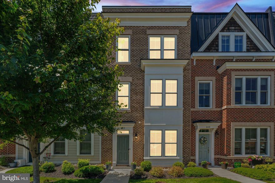 Welcome to this stunning 4-bedroom, 3.5-bath luxury townhome located in the heart of Vienna’s highly sought-after Cadence on Center community. Built in 2019 by renowned builder Sekas Homes, this elegant residence offers 2,285 square feet of beautifully finished living space across three thoughtfully designed levels. Step inside to discover high ceilings, wide-plank flooring, and an open-concept layout accented by high-end finishes throughout. The entry level features a bright and versatile room with a full bath perfect as a private guest suite, home office, or gym. Upstairs, the main level is designed for stylish entertaining and comfortable daily living. The gourmet kitchen showcases an oversized island with seating, expanded premium cabinetry with pantry storage and desk, a wine fridge, upgraded stainless steel appliances, and quartz countertops. The kitchen flows seamlessly into the spacious dining and living areas, complete with oversized windows and recessed lighting that flood the space with natural light. On the upper level, the luxurious primary suite offers a peaceful retreat with  en-suite bath featuring dual vanities, a glass-enclosed shower, and dual walk in closets. Two additional bedrooms and a beautifully appointed full bath provide room for family or guests, while a convenient laundry room adds ease to everyday life. Step outside to your own rooftop escape an expansive private terrace with a fireplace, ideal for al fresco dining, lounging under the stars, or cultivating your rooftop garden. Additional features include a two-car rear-loading garage with custom built-in wall and ceiling shelving, plus bike racks for optimal organization and storage equating to 450 cubic feet. Ideally situated just steps from Vienna’s charming Church Street and Maple Avenue, this exceptional home offers walkable access to shopping, dining, cafés, local parks, and the W&OD Trail. Experience upscale living in one of Vienna’s most walkable neighborhoods. Vienna/Thoreau/Madison Pyramid.
